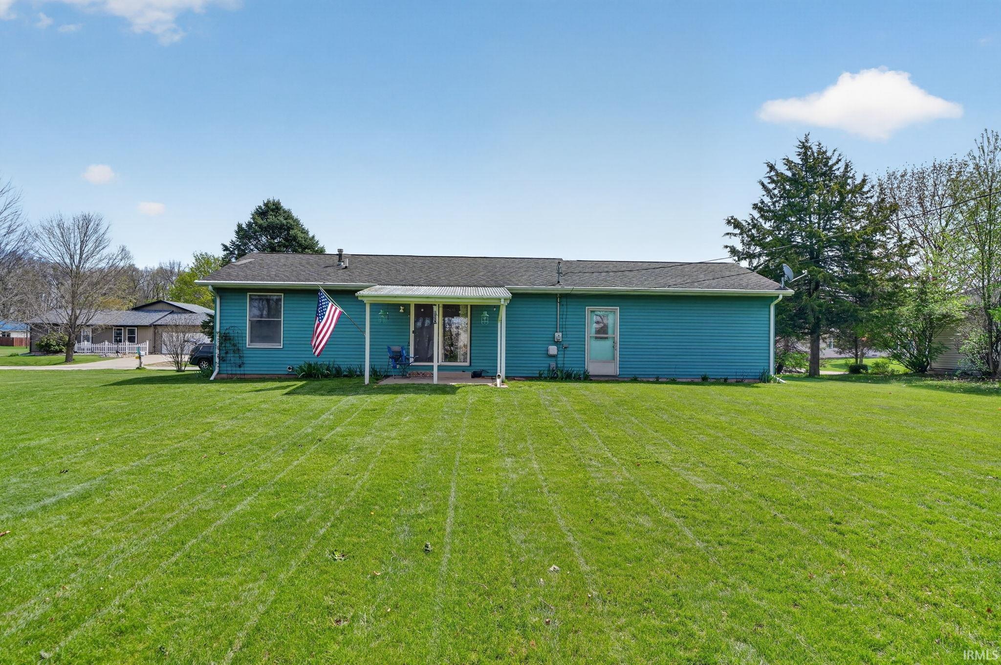 Back of house with a lawn