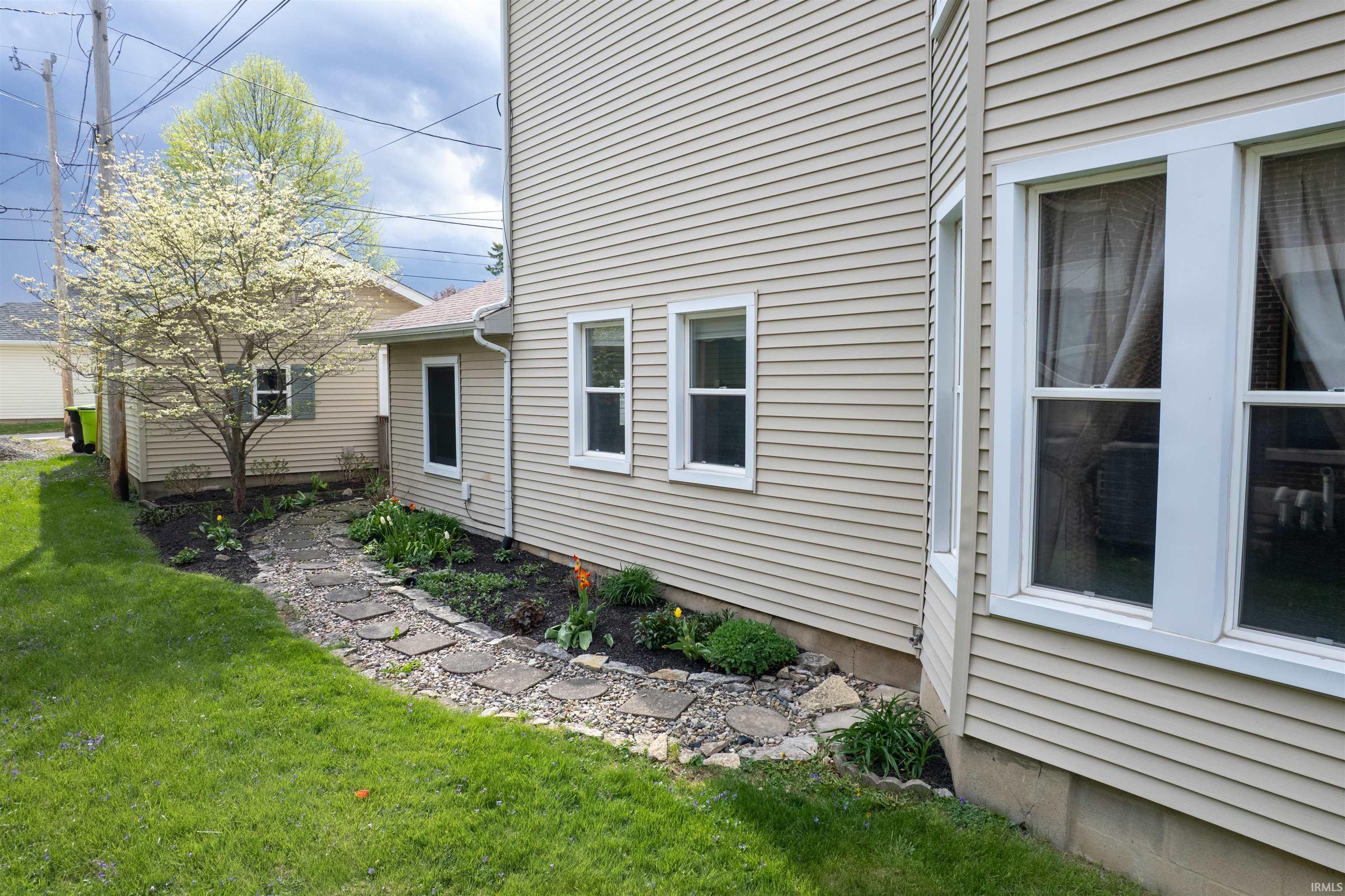 View of side of property featuring a yard