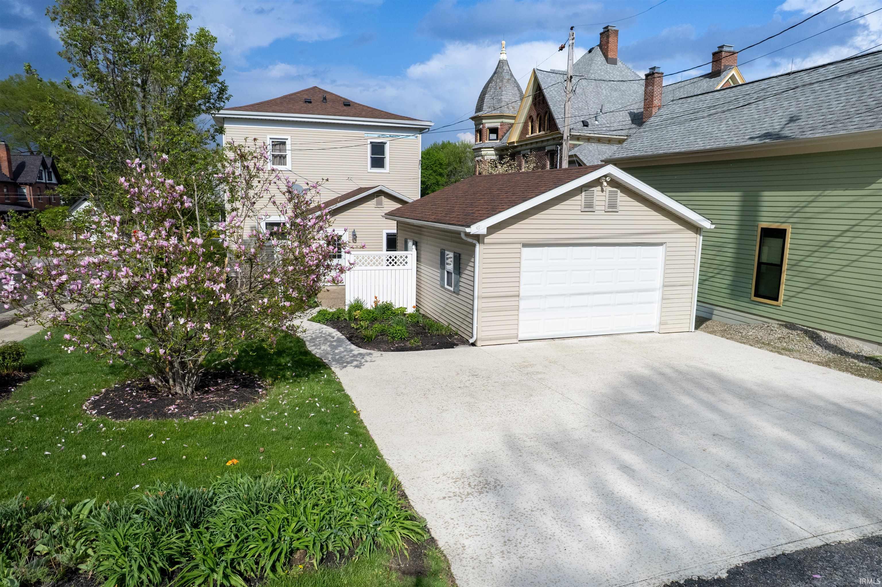 View of front of property with a garage and an outdoor structure