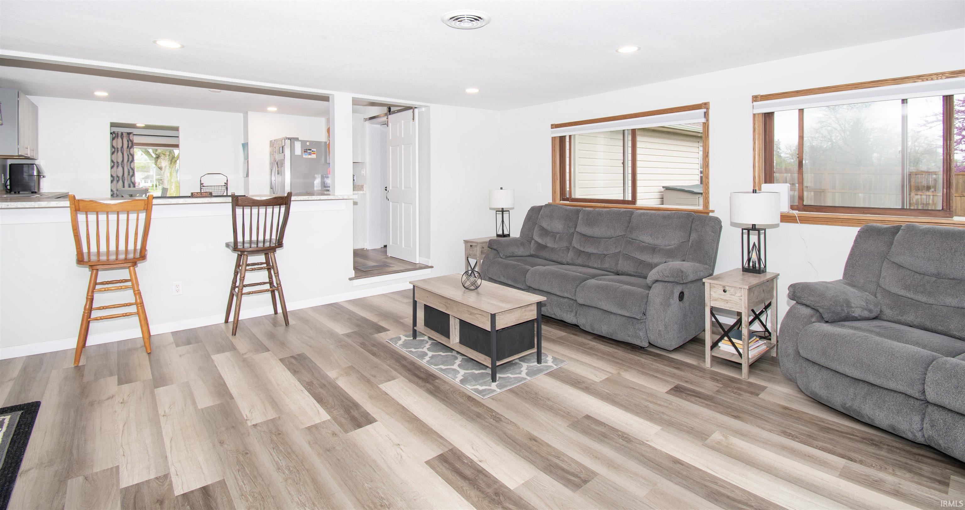 Living room featuring light wood finished floors and recessed lighting