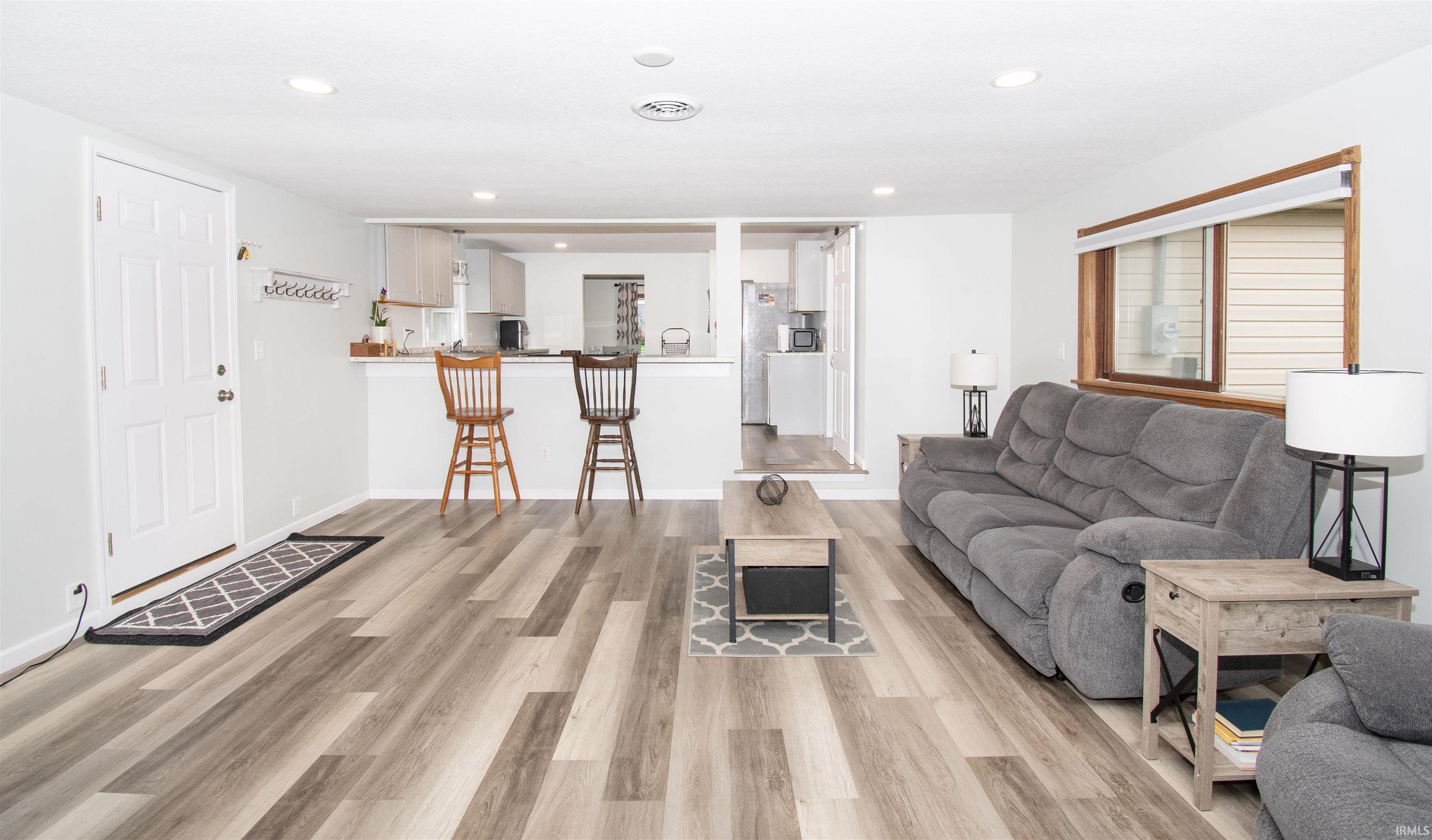 Living area featuring light wood-type flooring and recessed lighting
