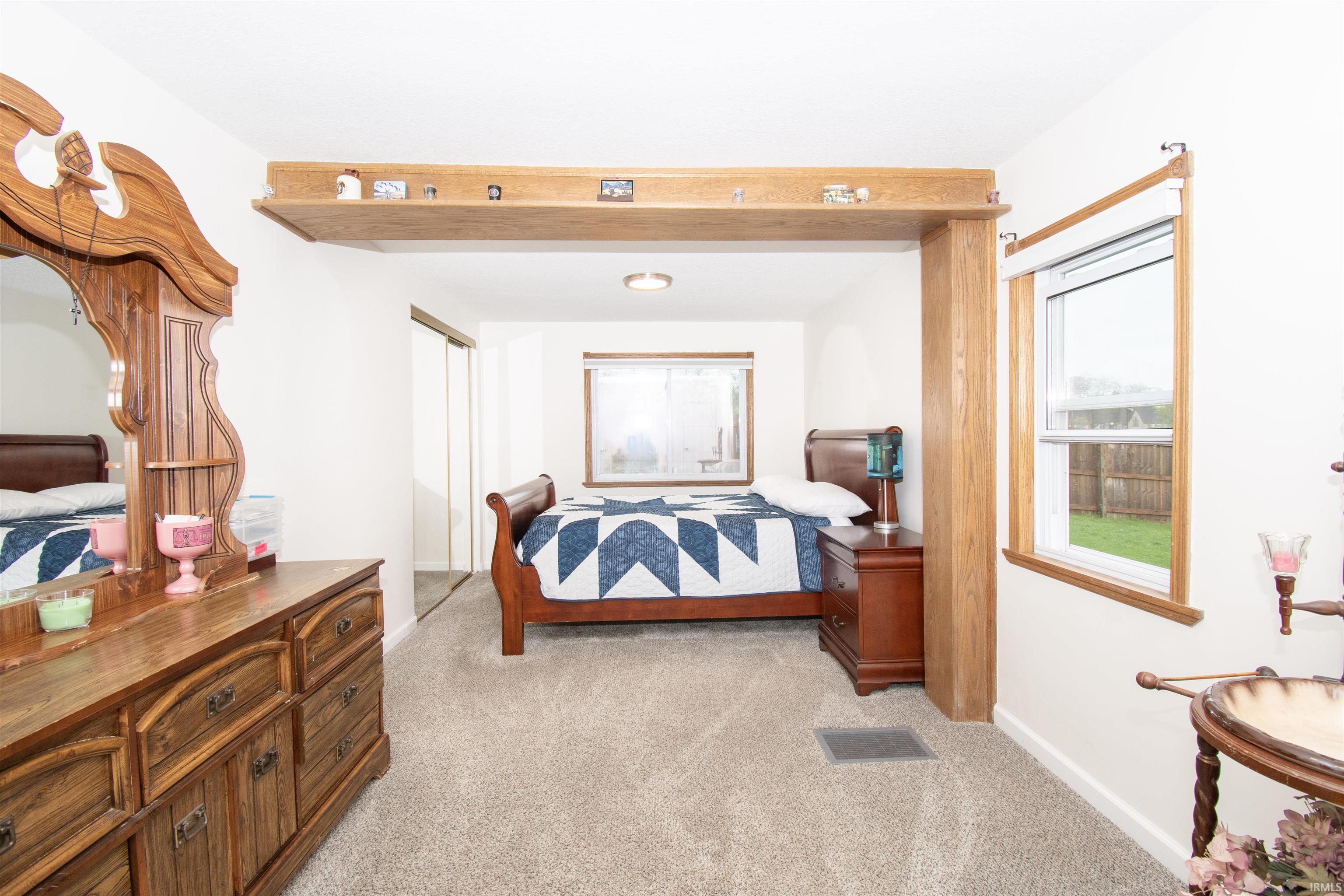 Bedroom featuring light colored carpet and a closet