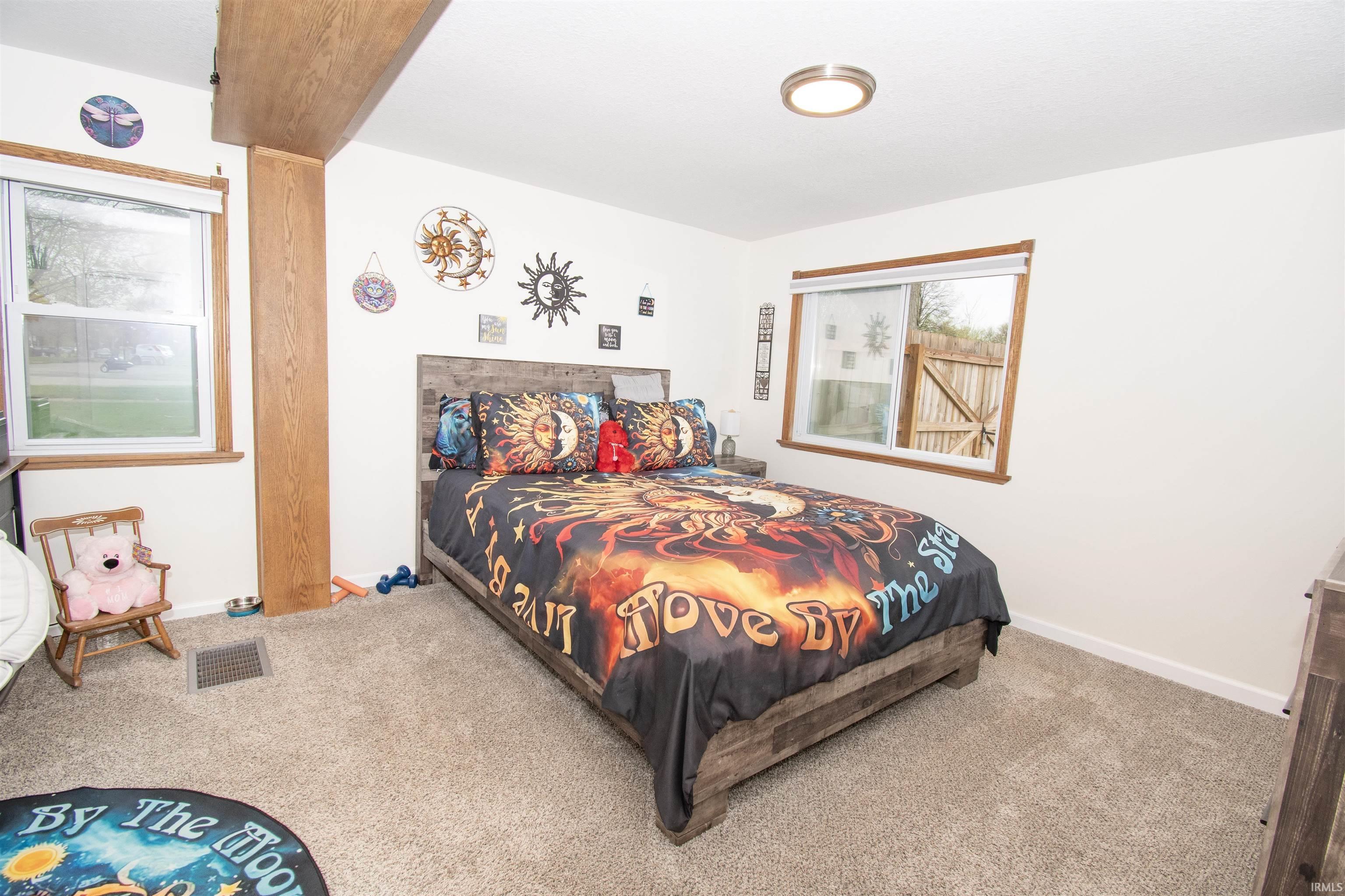 Carpeted bedroom featuring baseboards