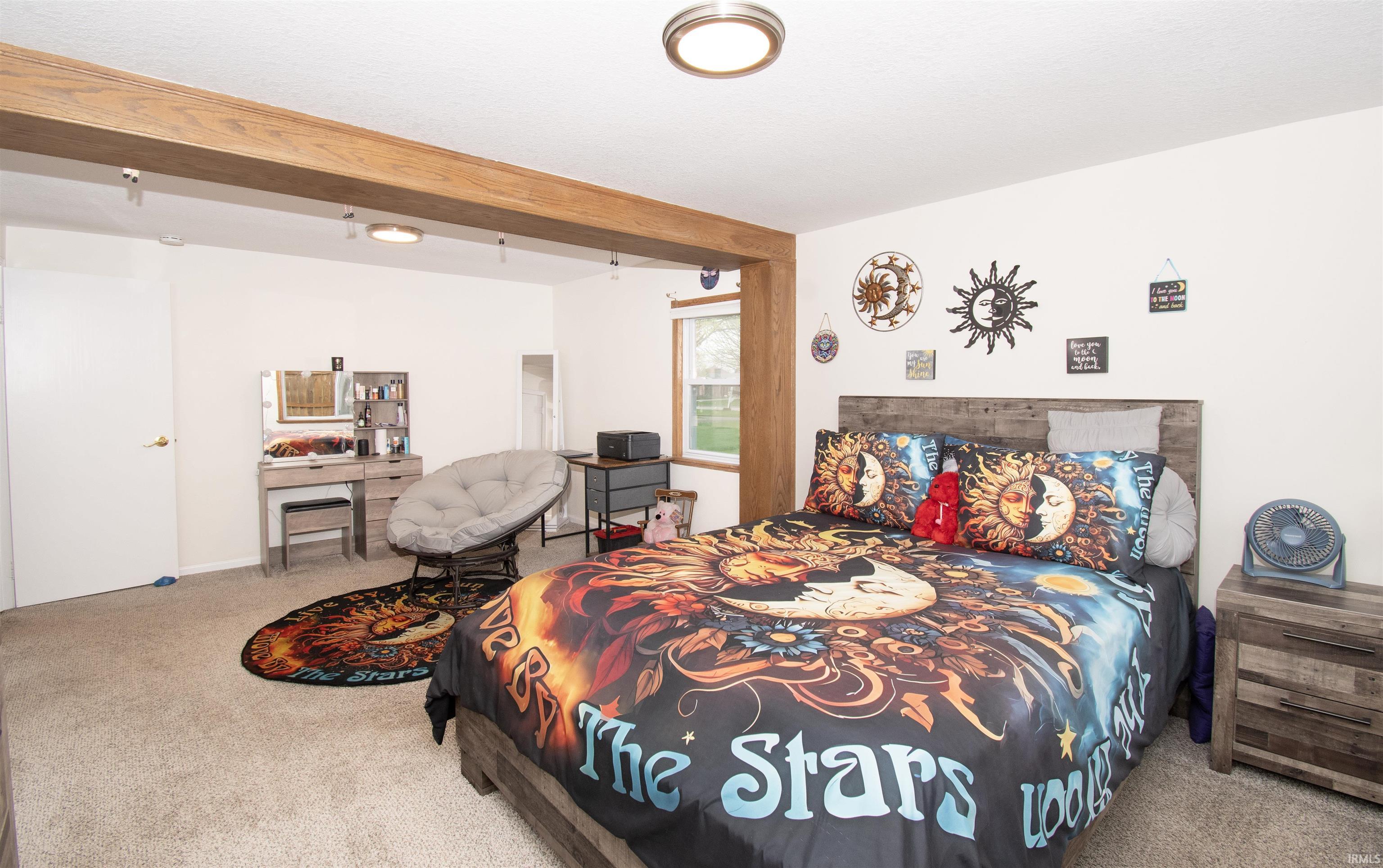 Bedroom featuring light colored carpet