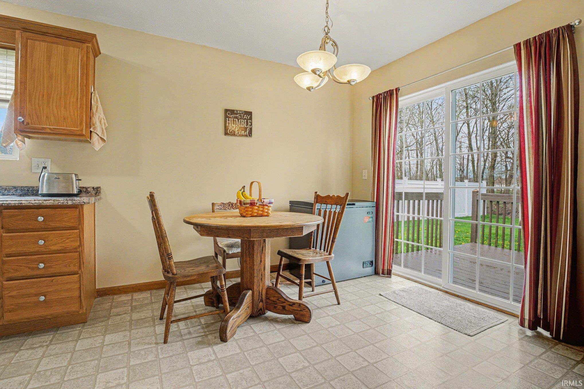 Dining room featuring light flooring and a chandelier