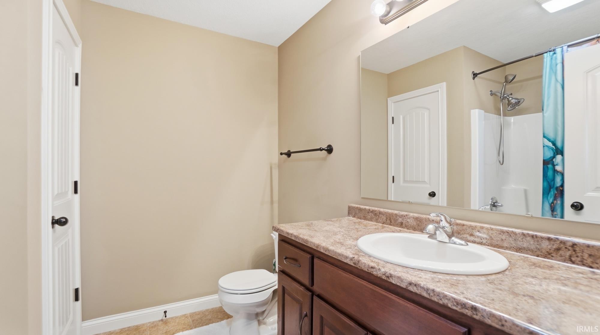 Full bathroom featuring a shower with curtain and vanity