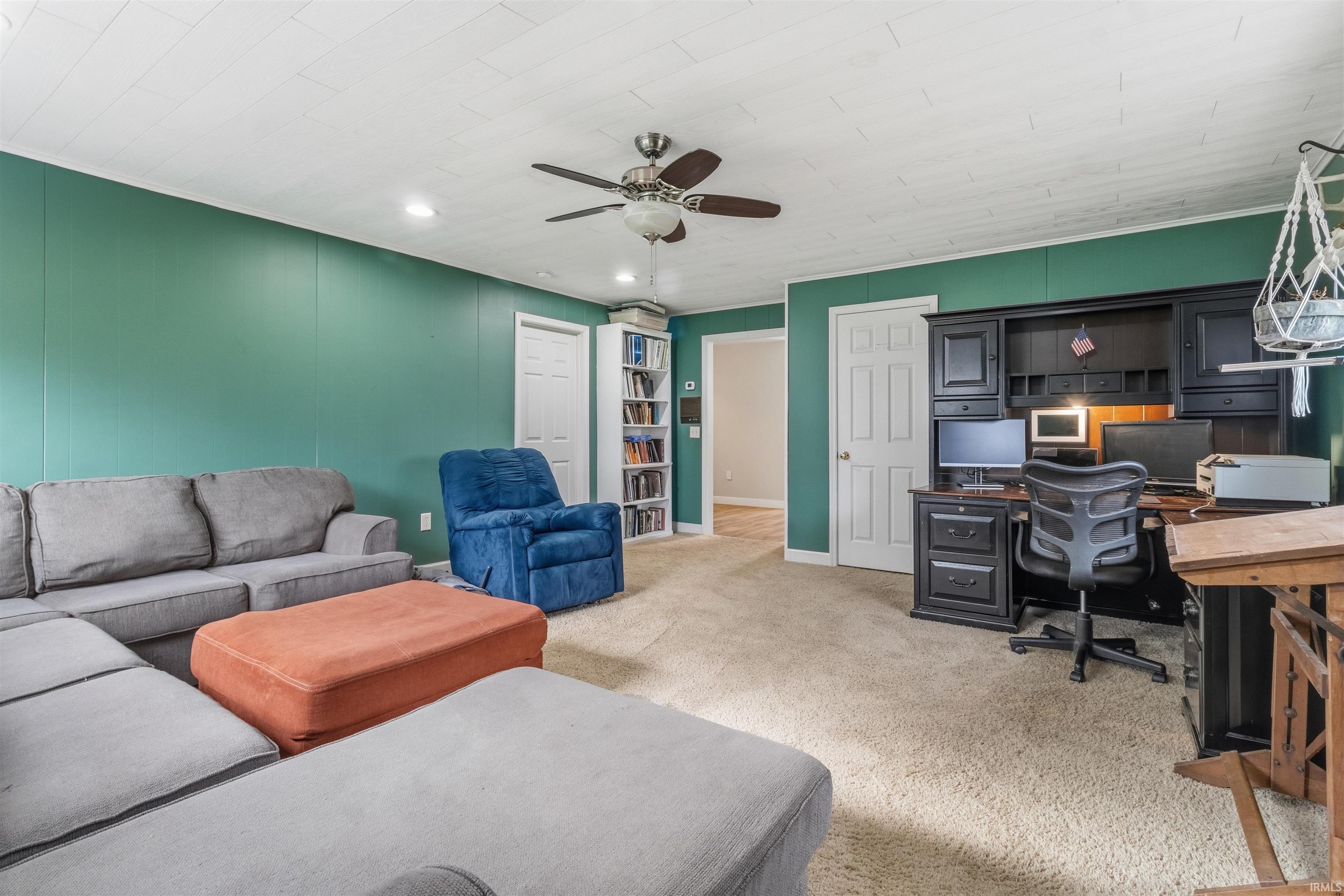 Home office featuring light colored carpet, a ceiling fan, and recessed lighting