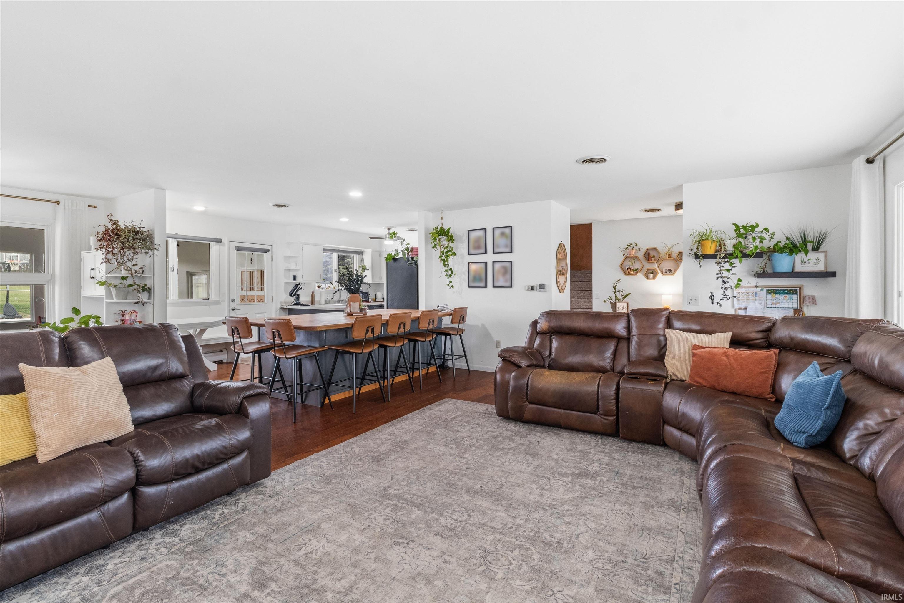 Living room with wood finished floors and recessed lighting