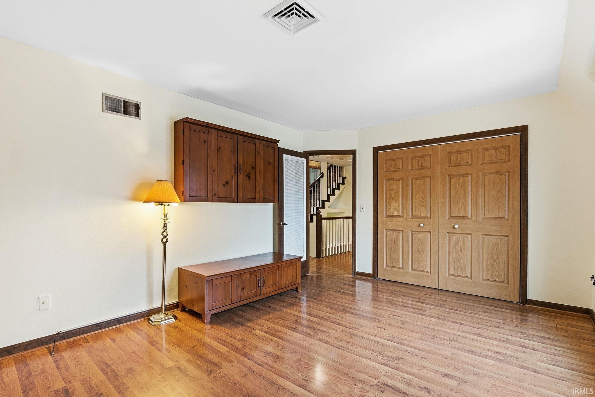 Unfurnished bedroom with a closet and light wood-type flooring