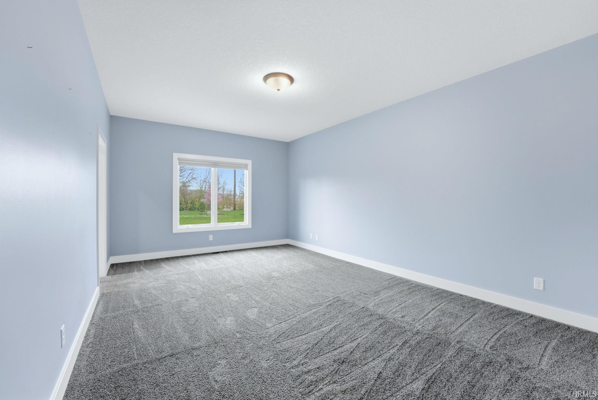 Empty room featuring carpet floors and baseboards