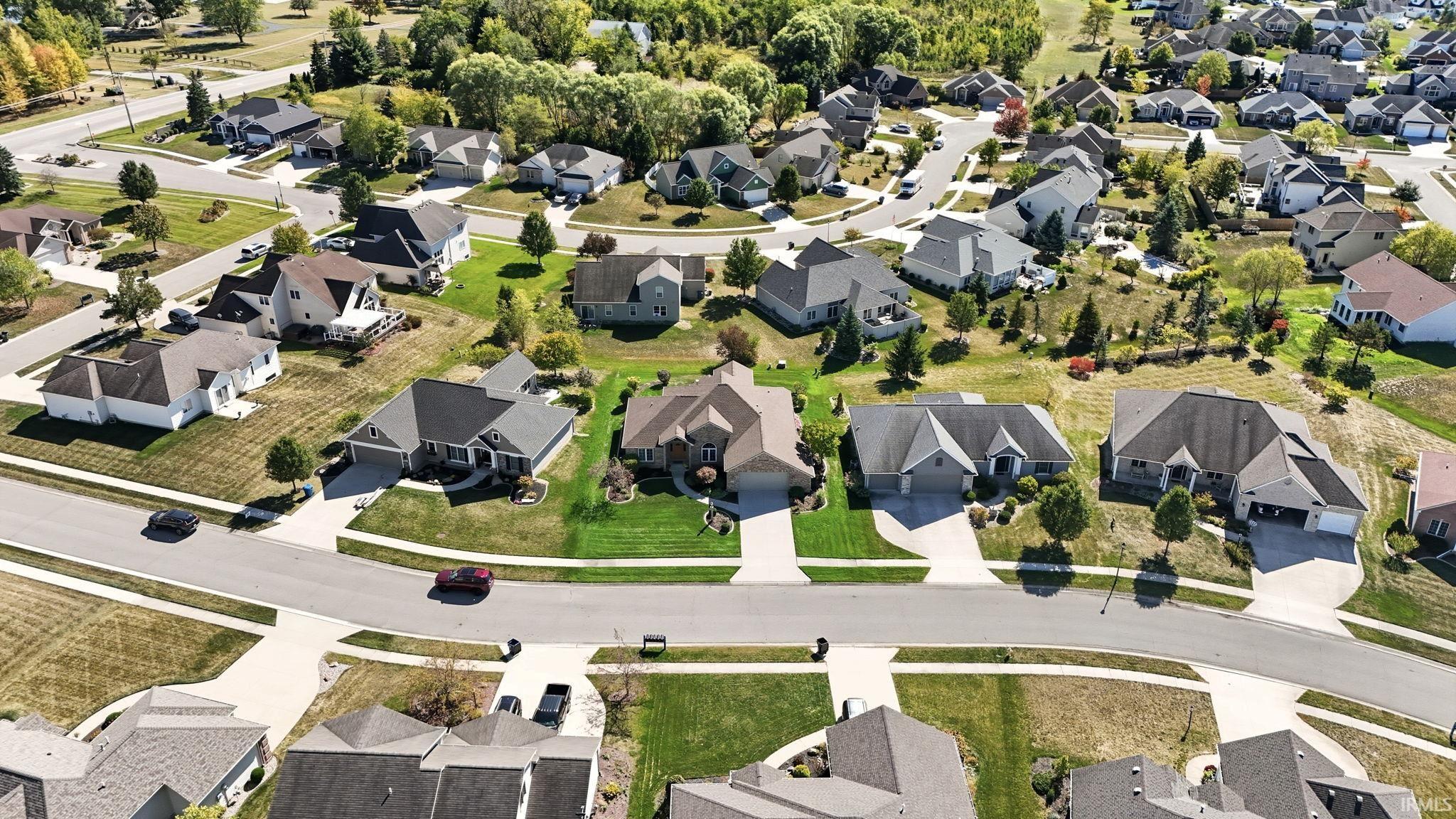 Aerial view of a residential neighborhood with paved streets and sidewalks