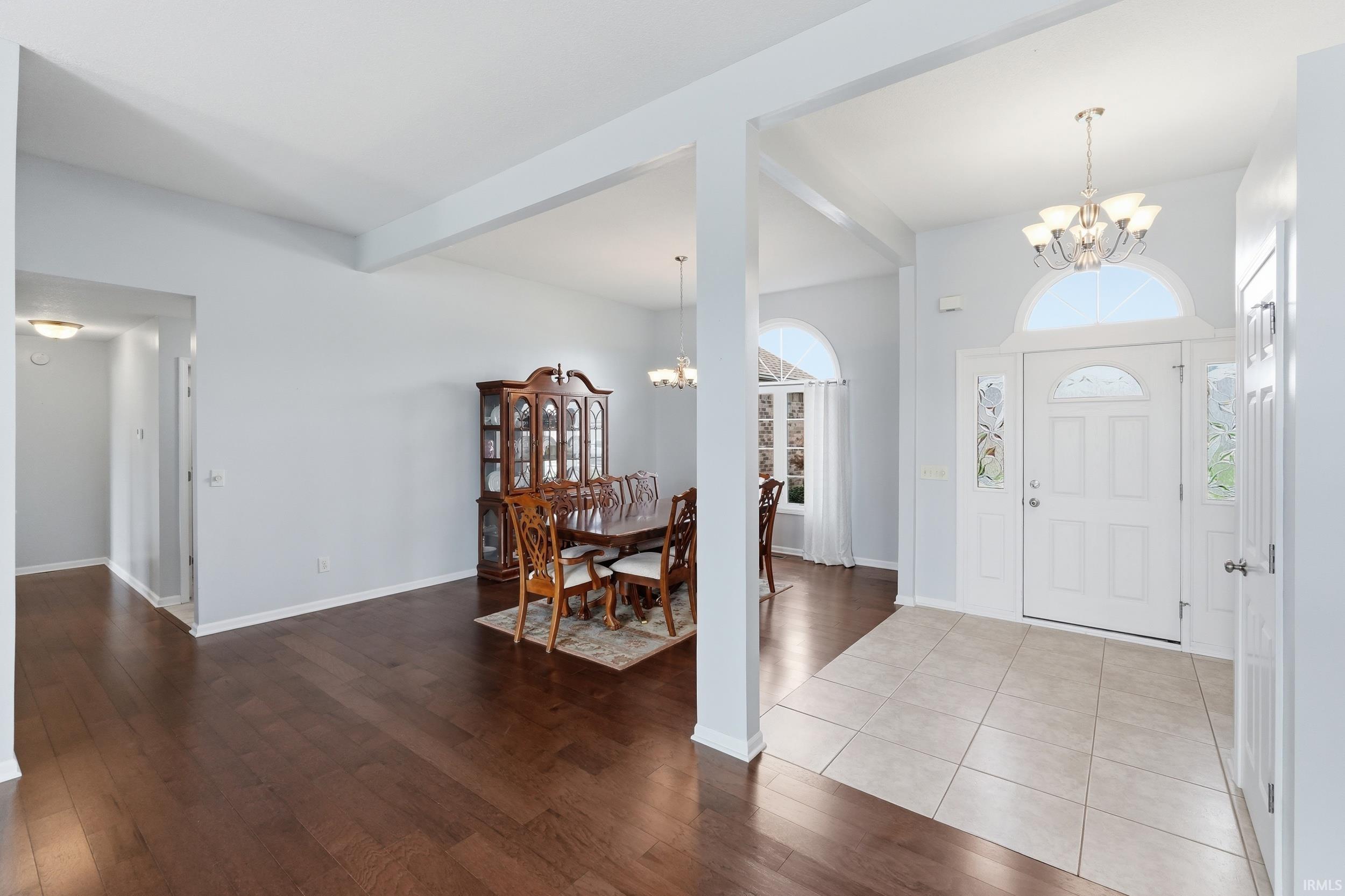 Entrance foyer with a chandelier and dark wood-type flooring