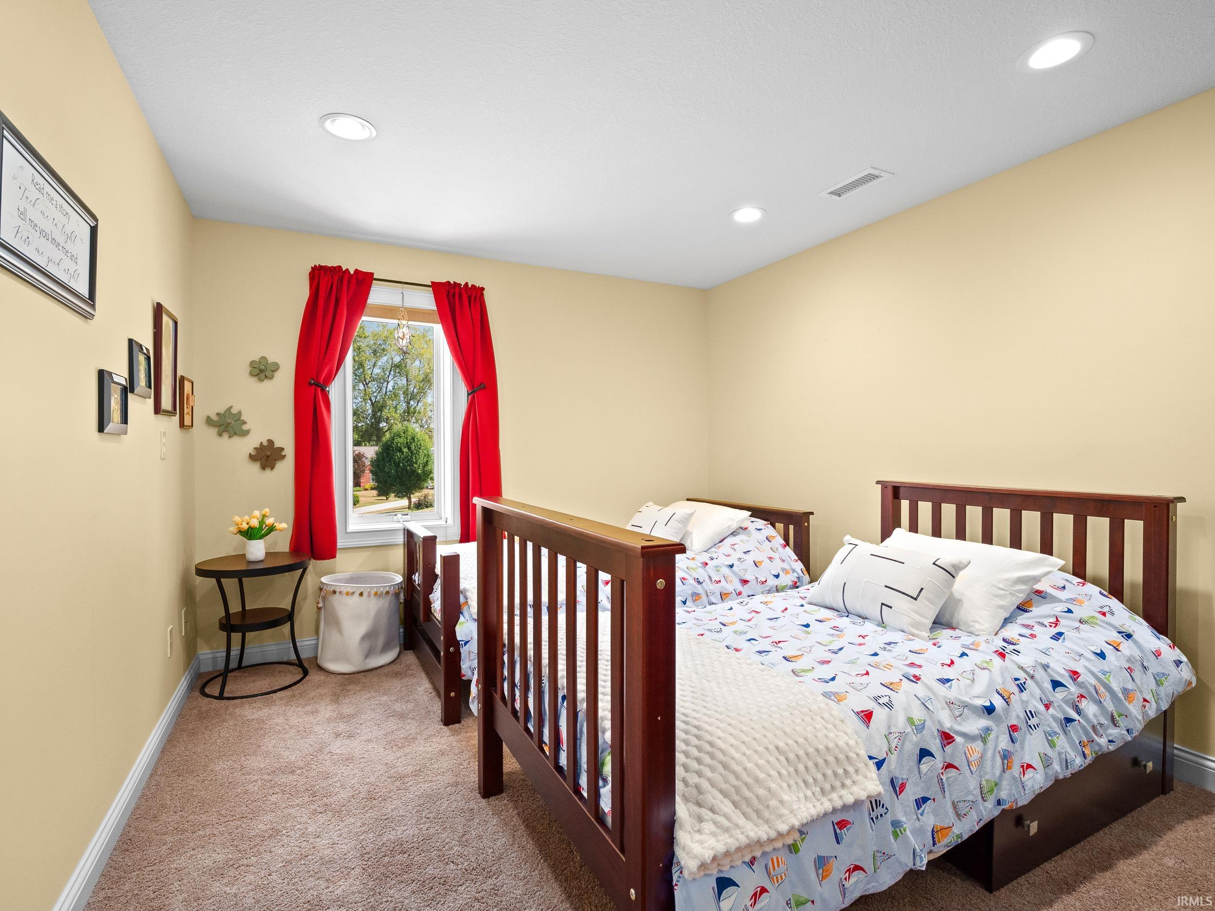 Carpeted bedroom featuring baseboards