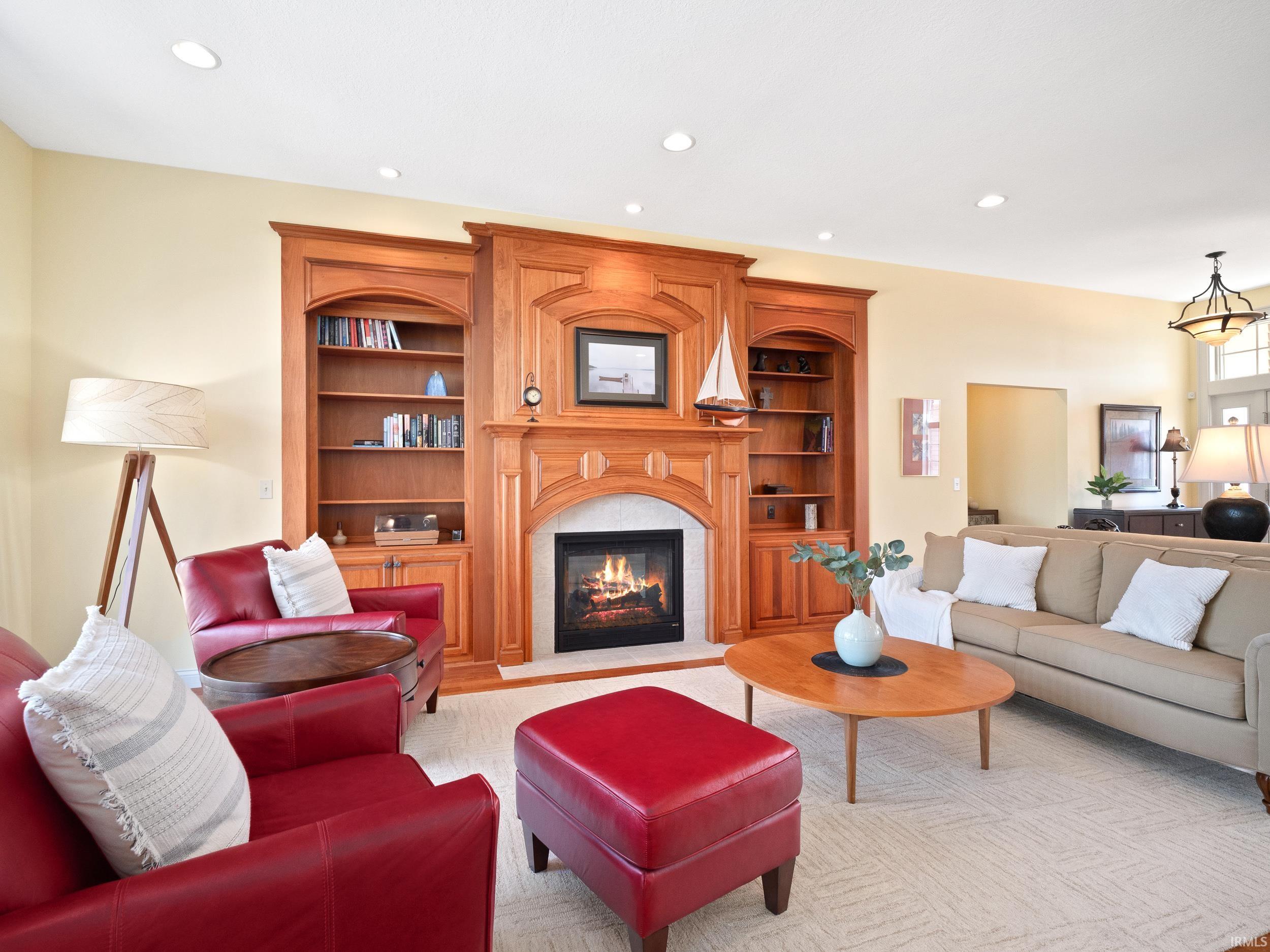 Living room featuring built in features, a fireplace, and recessed lighting