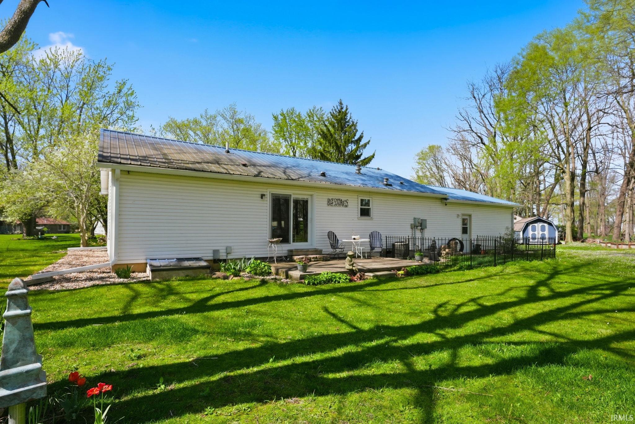Back of house with a lawn