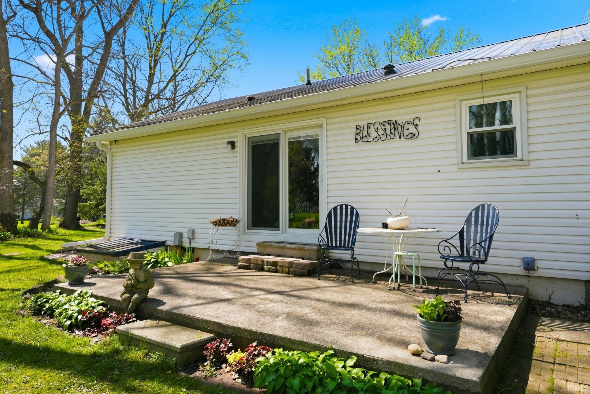 Back of house with a patio, a metal roof, and entry steps