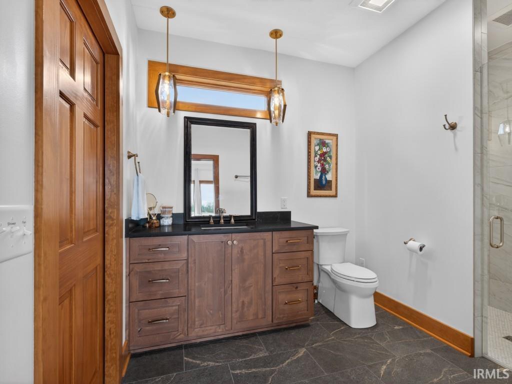 Full bath with vanity and a shower stall