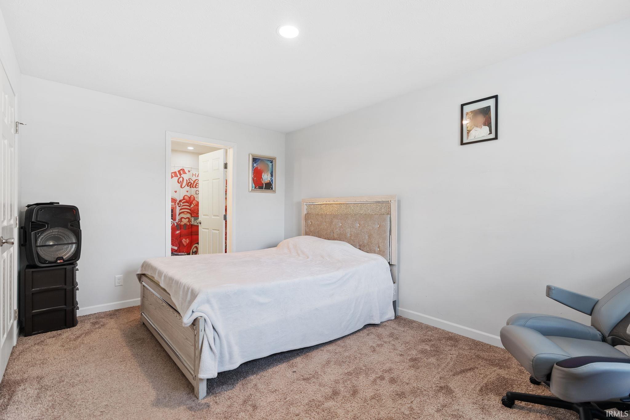 Bedroom featuring light colored carpet and recessed lighting