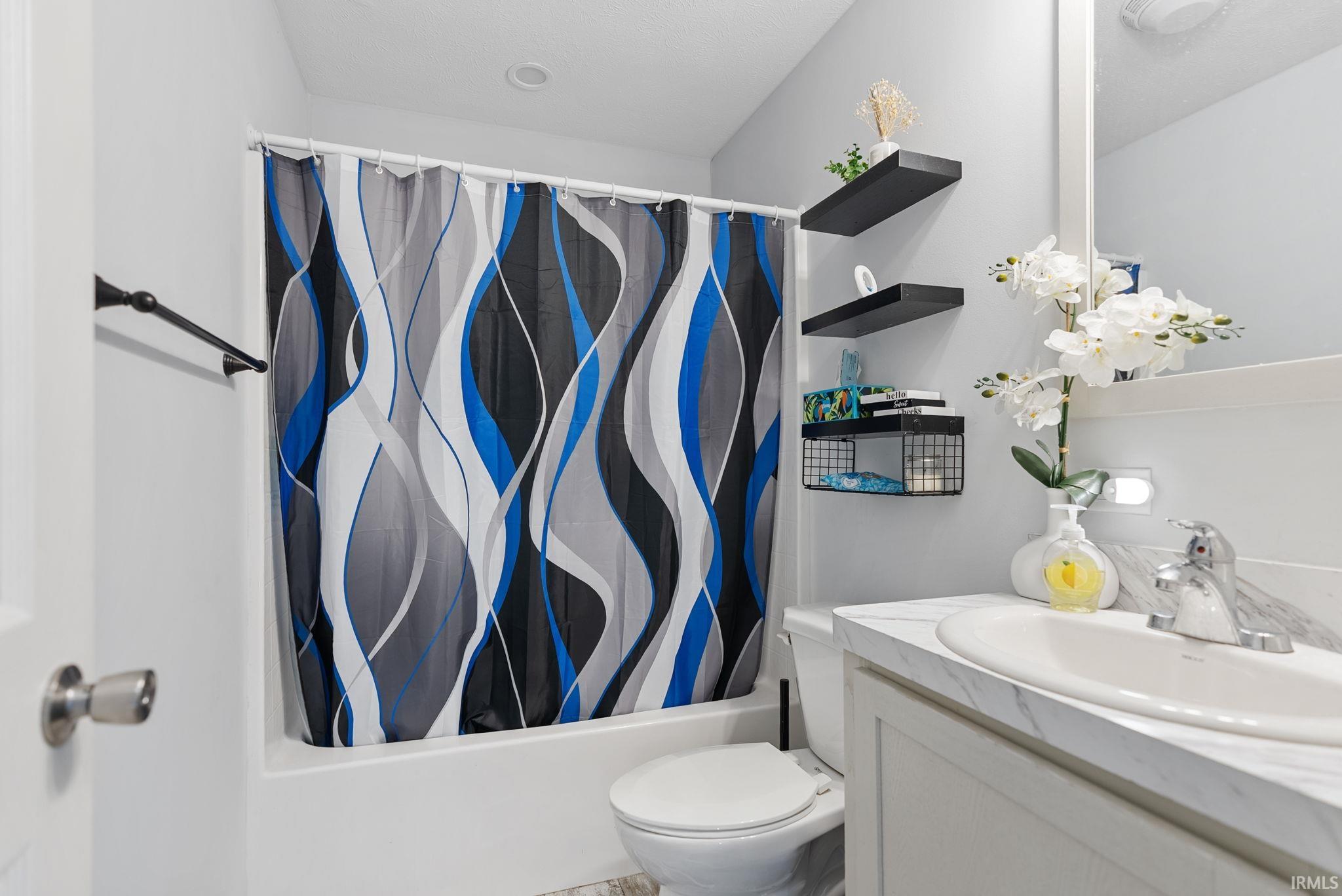 Full bath featuring vanity and shower / bath combo