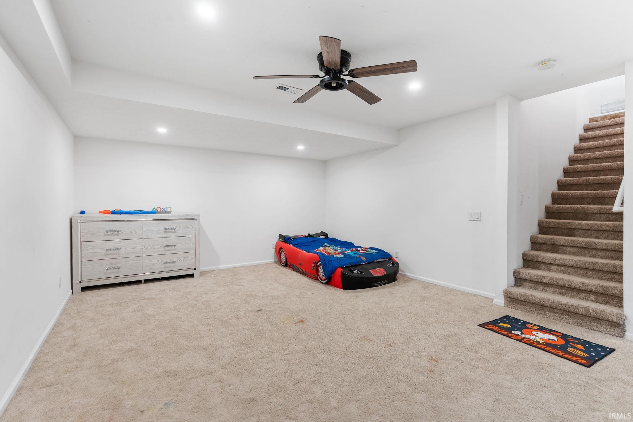 Bedroom featuring ceiling fan, light carpet, and recessed lighting