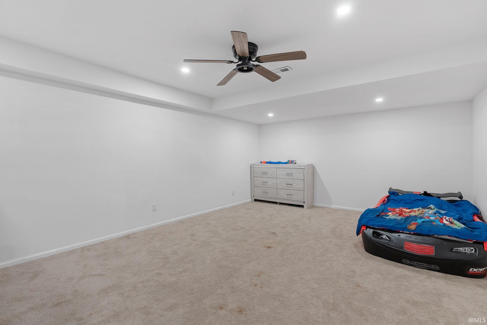 Unfurnished bedroom with carpet, ceiling fan, and recessed lighting