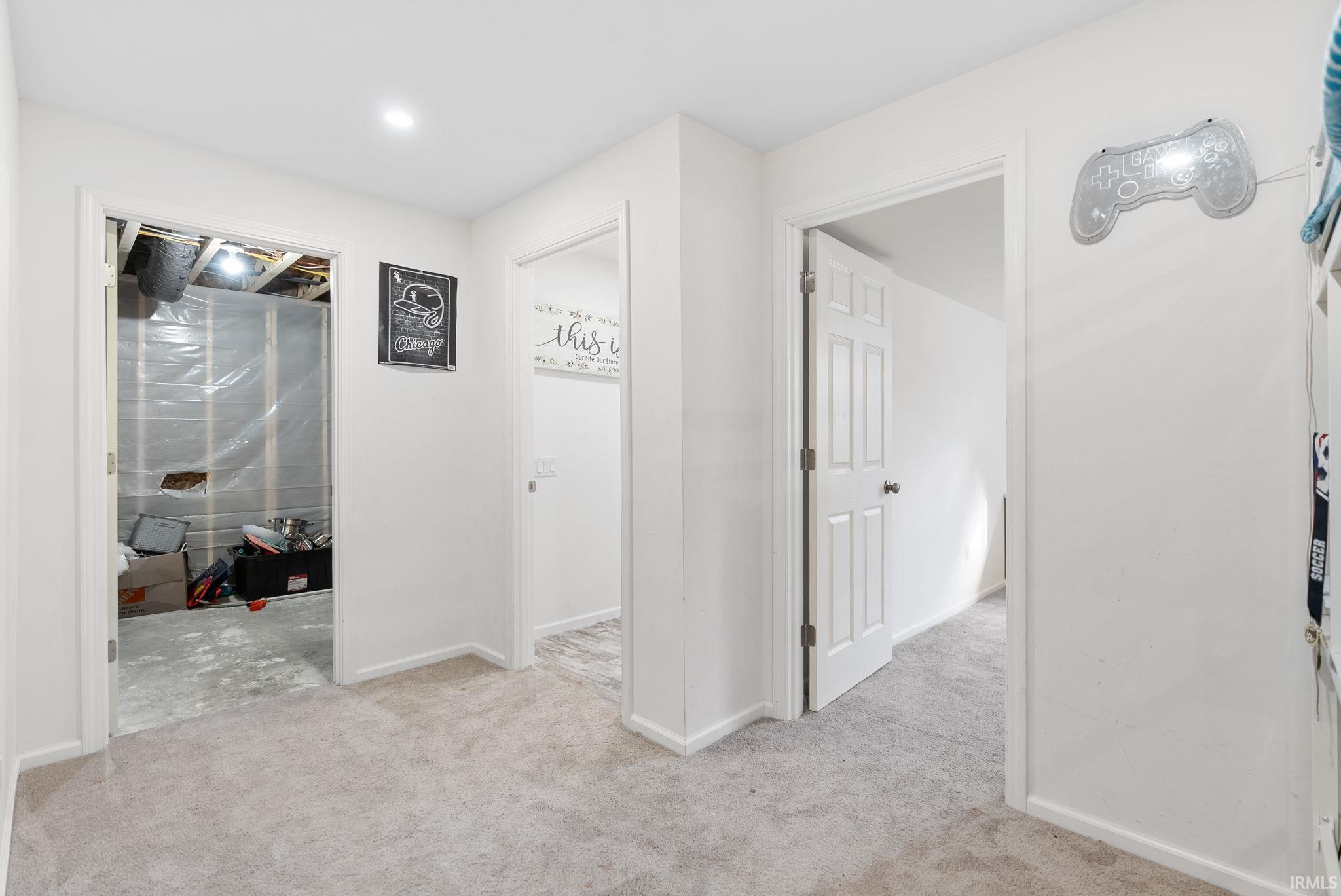 Hall featuring light colored carpet and recessed lighting