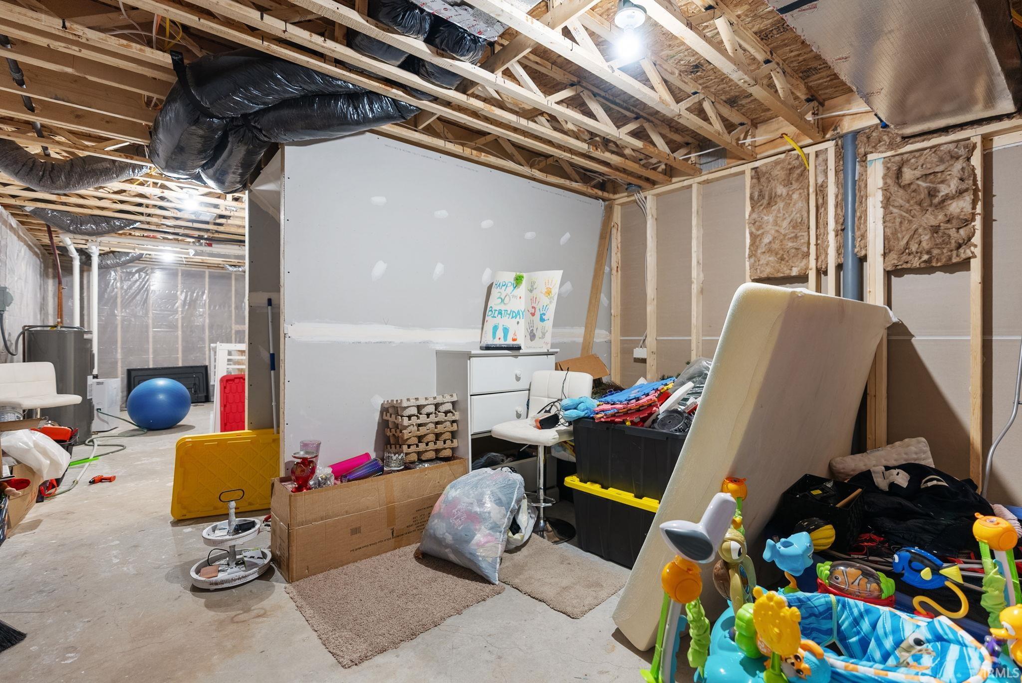 Unfinished basement featuring water heater