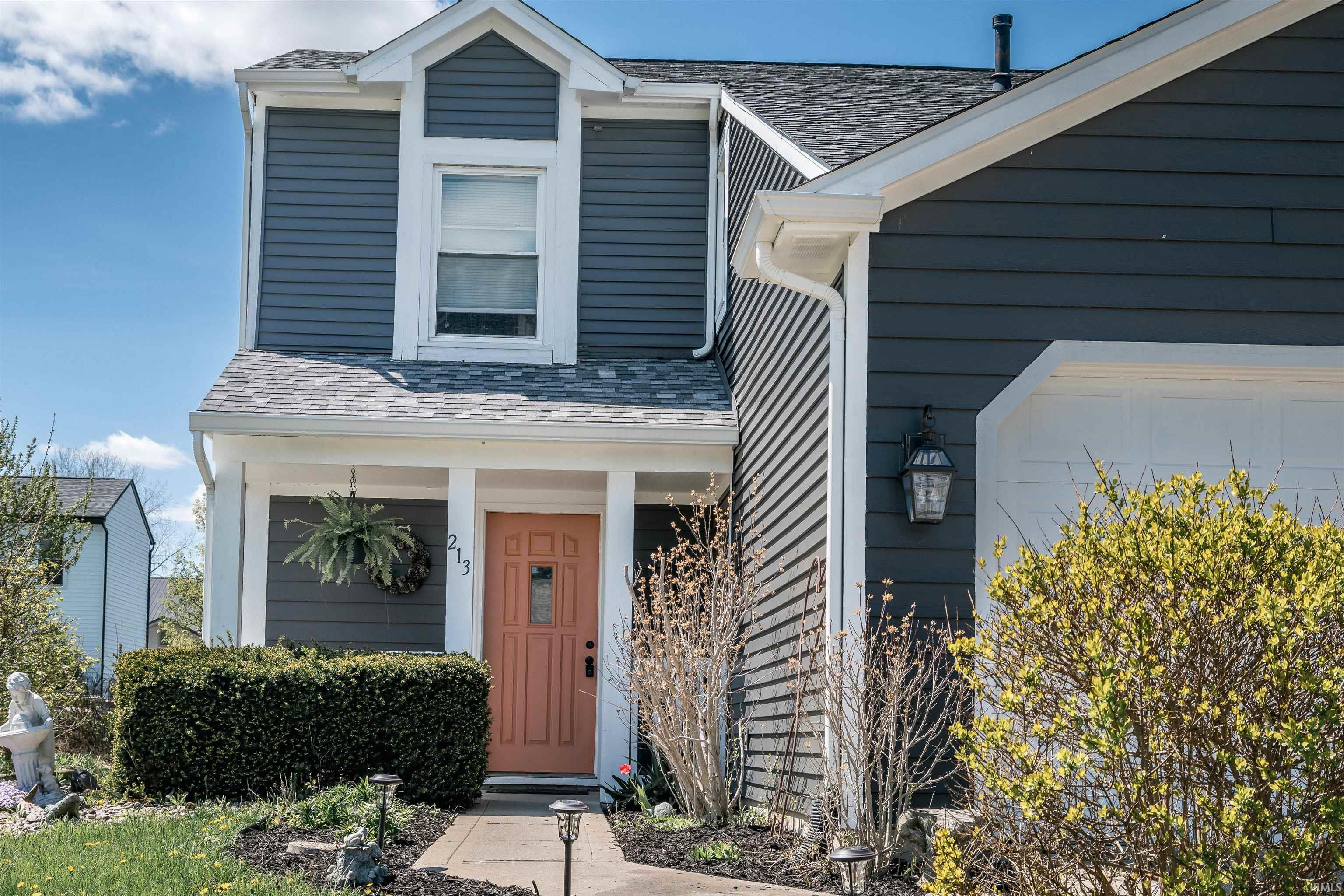 View of front of house featuring a shingled roof and covered porch