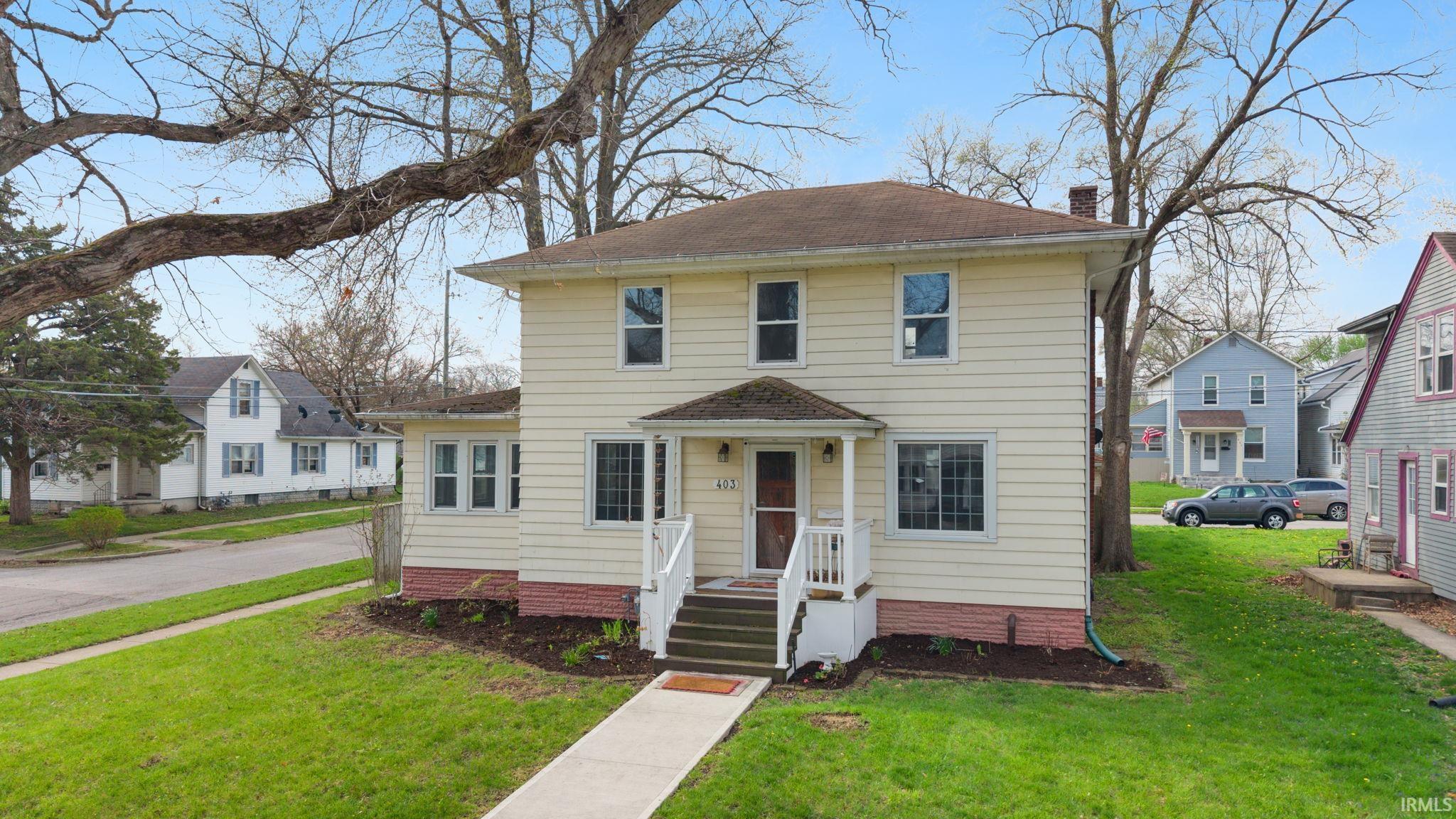 View of front of property featuring a front yard and a chimney