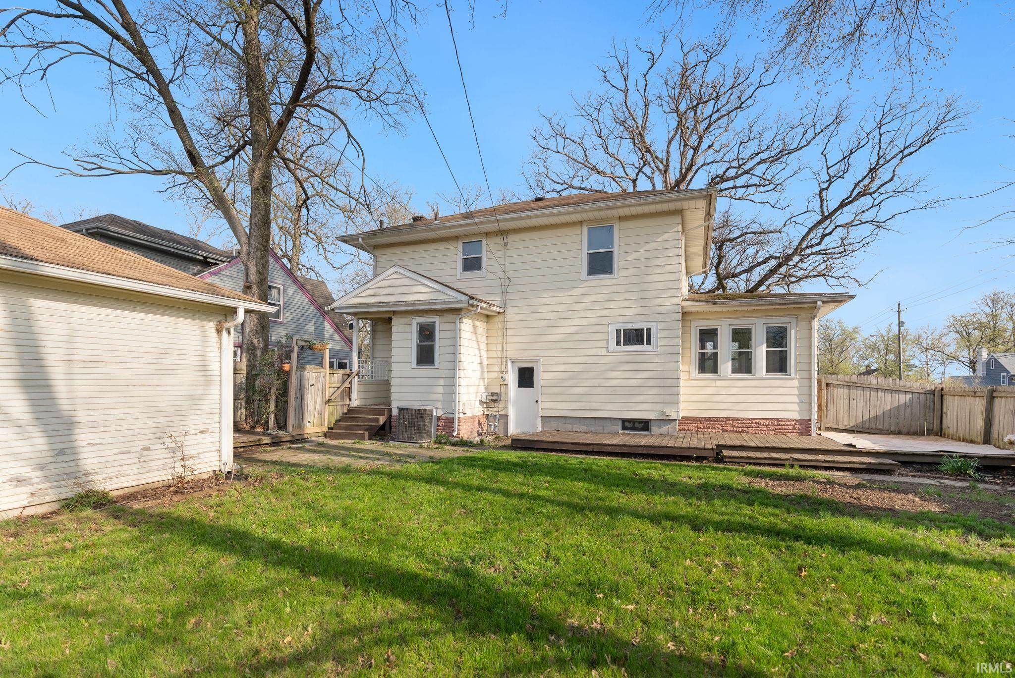 Back of property featuring a wooden deck