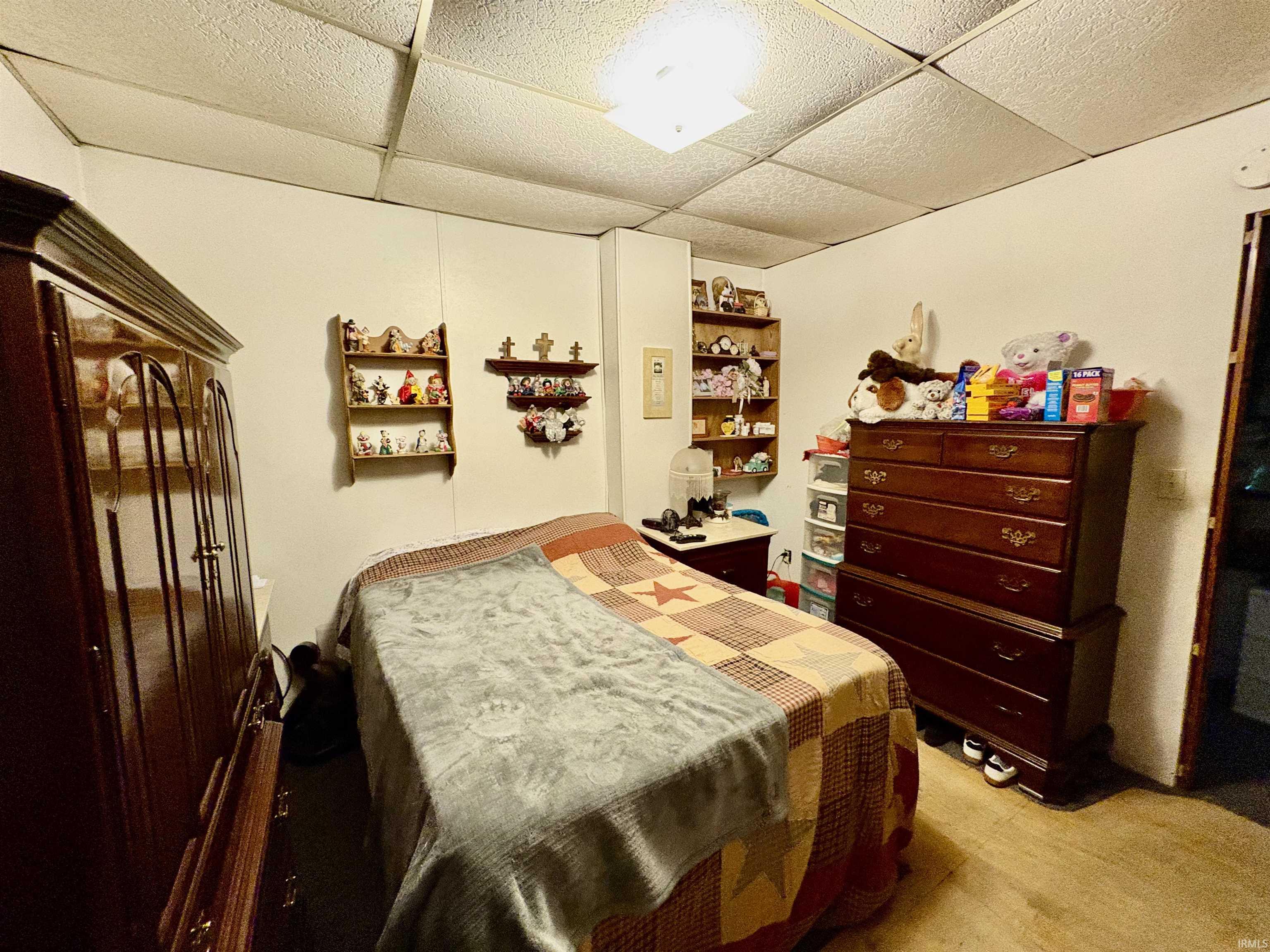 Carpeted bedroom with a drop ceiling