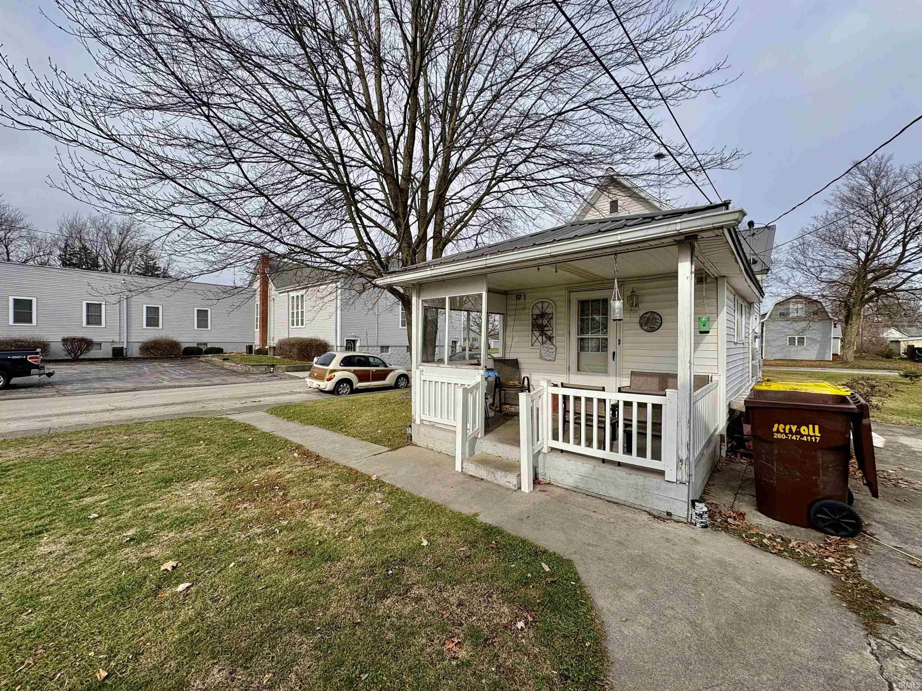 View of front facade with a porch and a front lawn