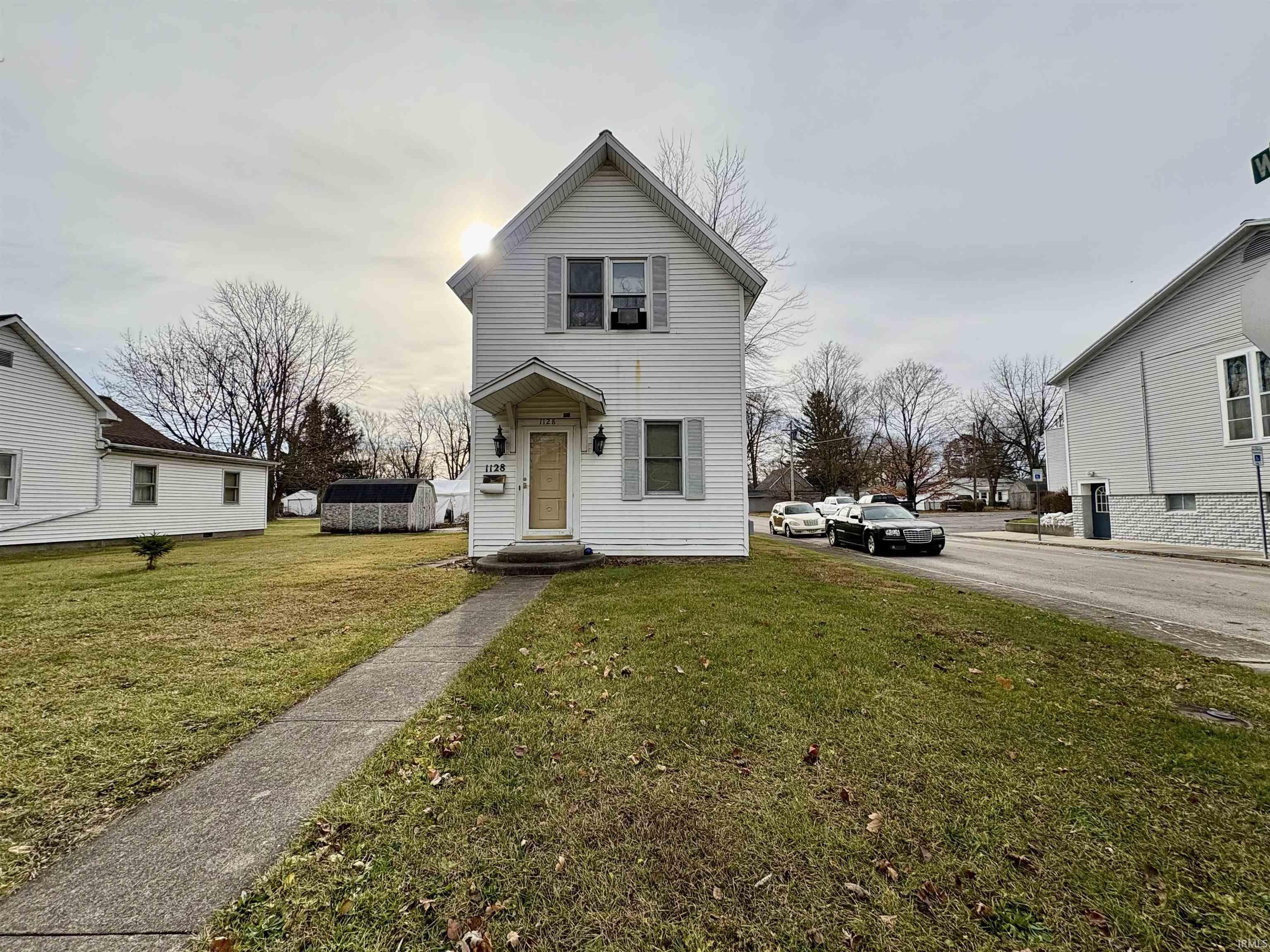 Traditional home with a front lawn