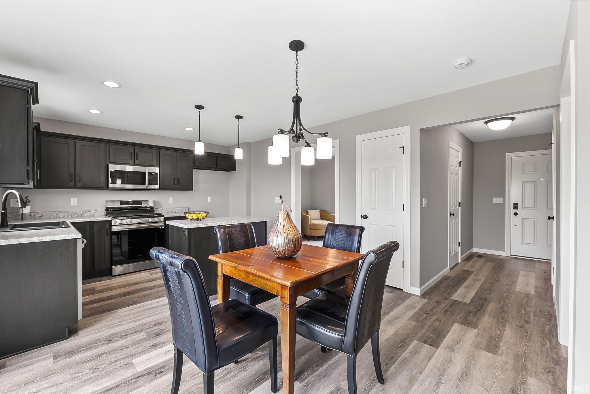 Open-concept kitchen and dining area featuring wood-finish flooring