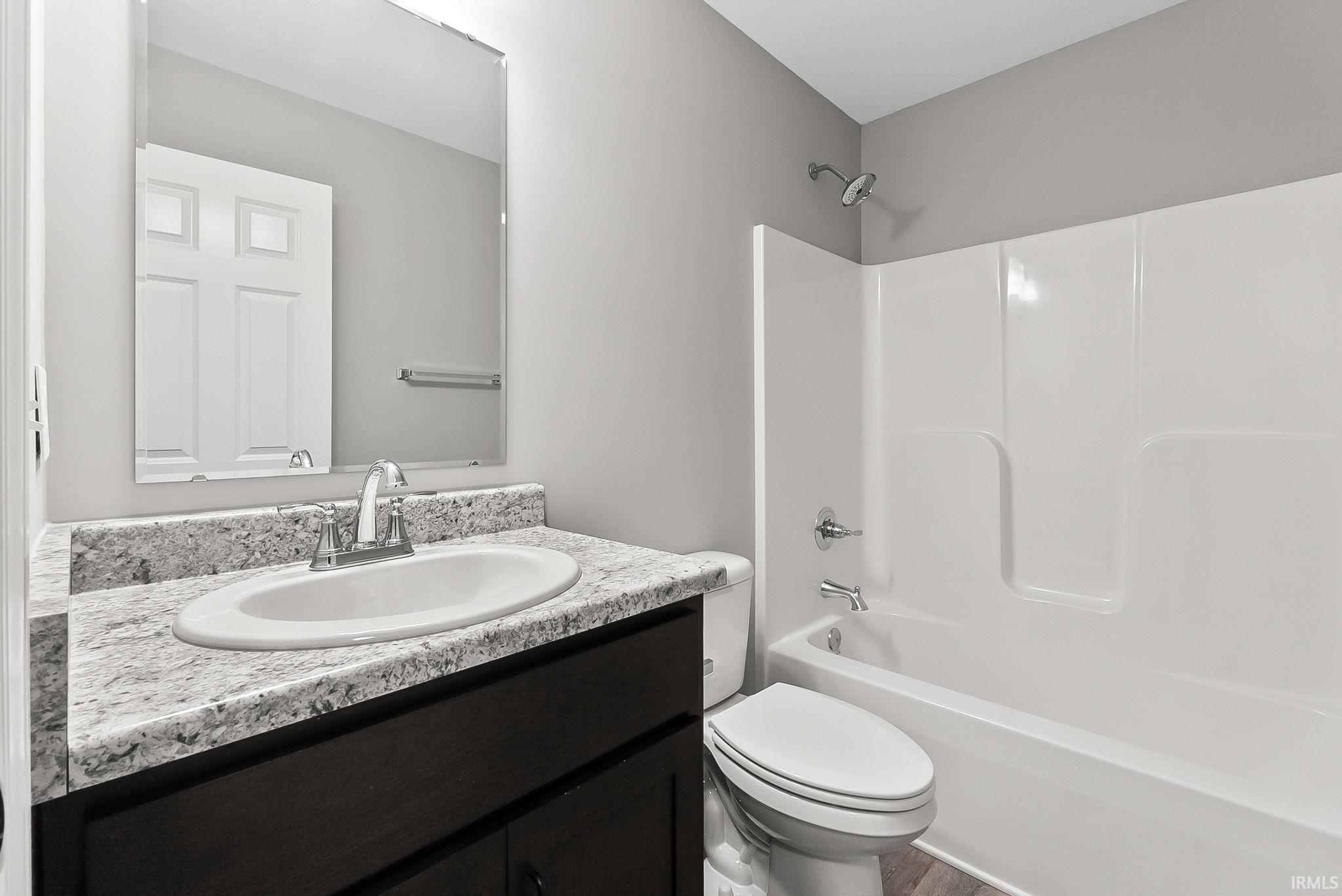 Bathroom featuring vanity and  shower combination