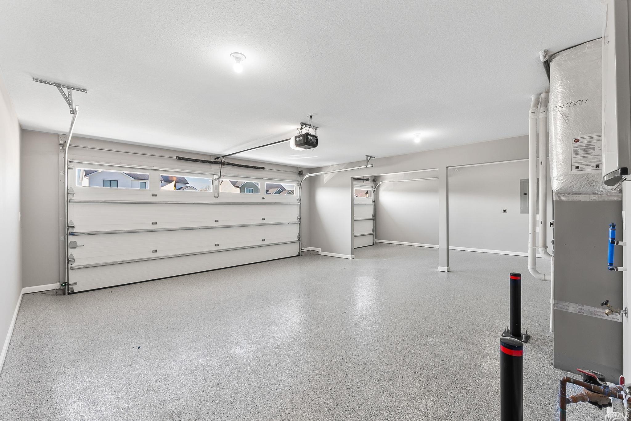 Garage featuring heating unit and a garage door opener