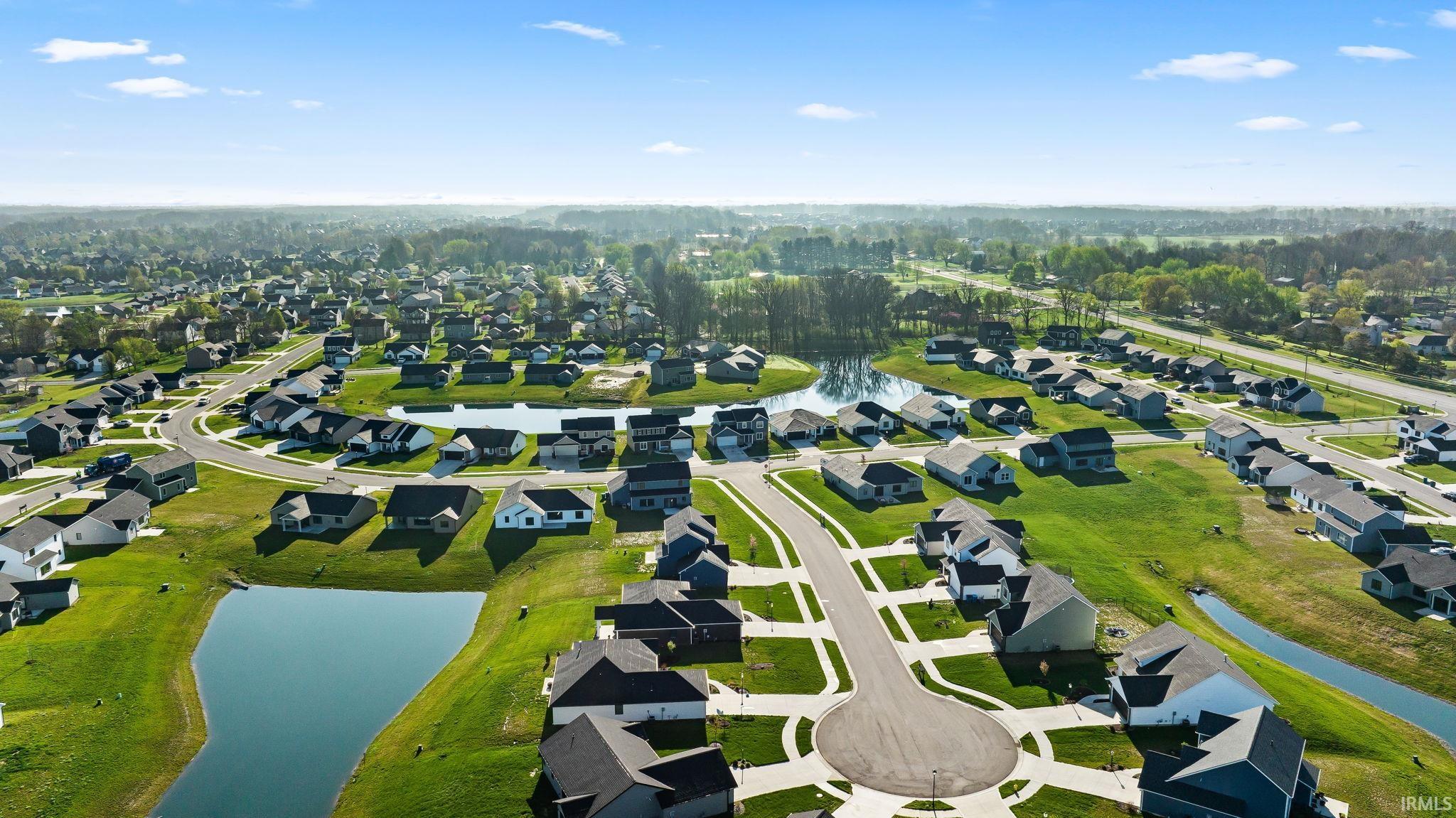 Aerial overview of property's location featuring nearby suburban area and a large body of water