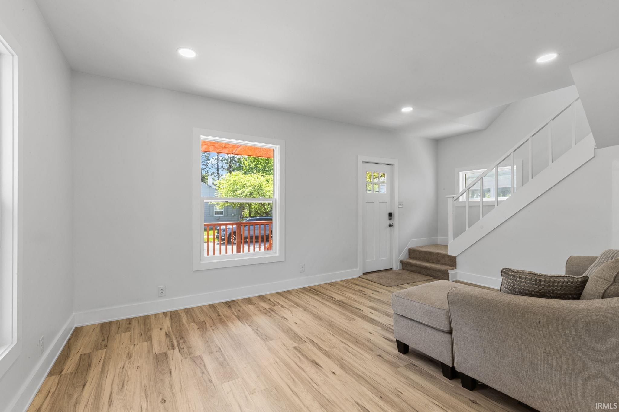 Foyer featuring light wood-style floors, recessed lighting, and plenty of natural light