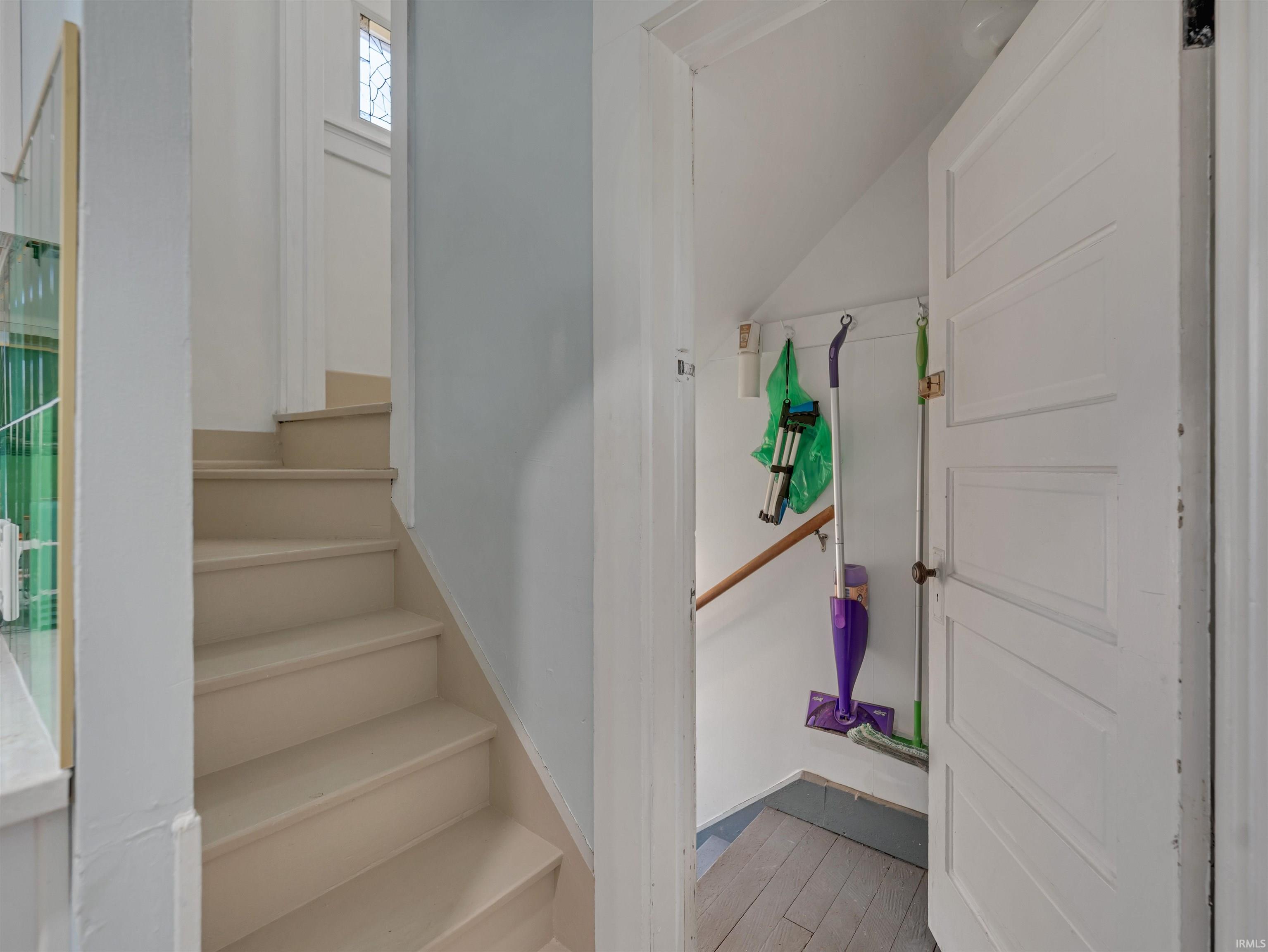 Stairs featuring hardwood / wood-style floors