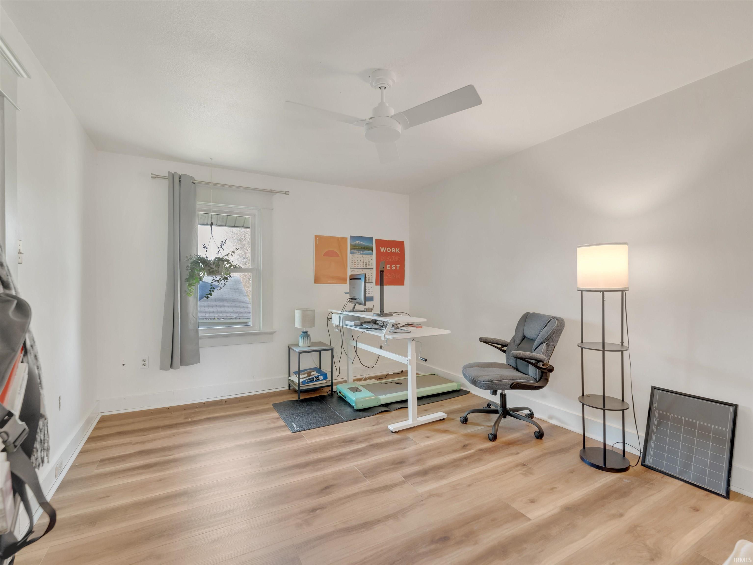 Home office featuring light wood-style floors and ceiling fan