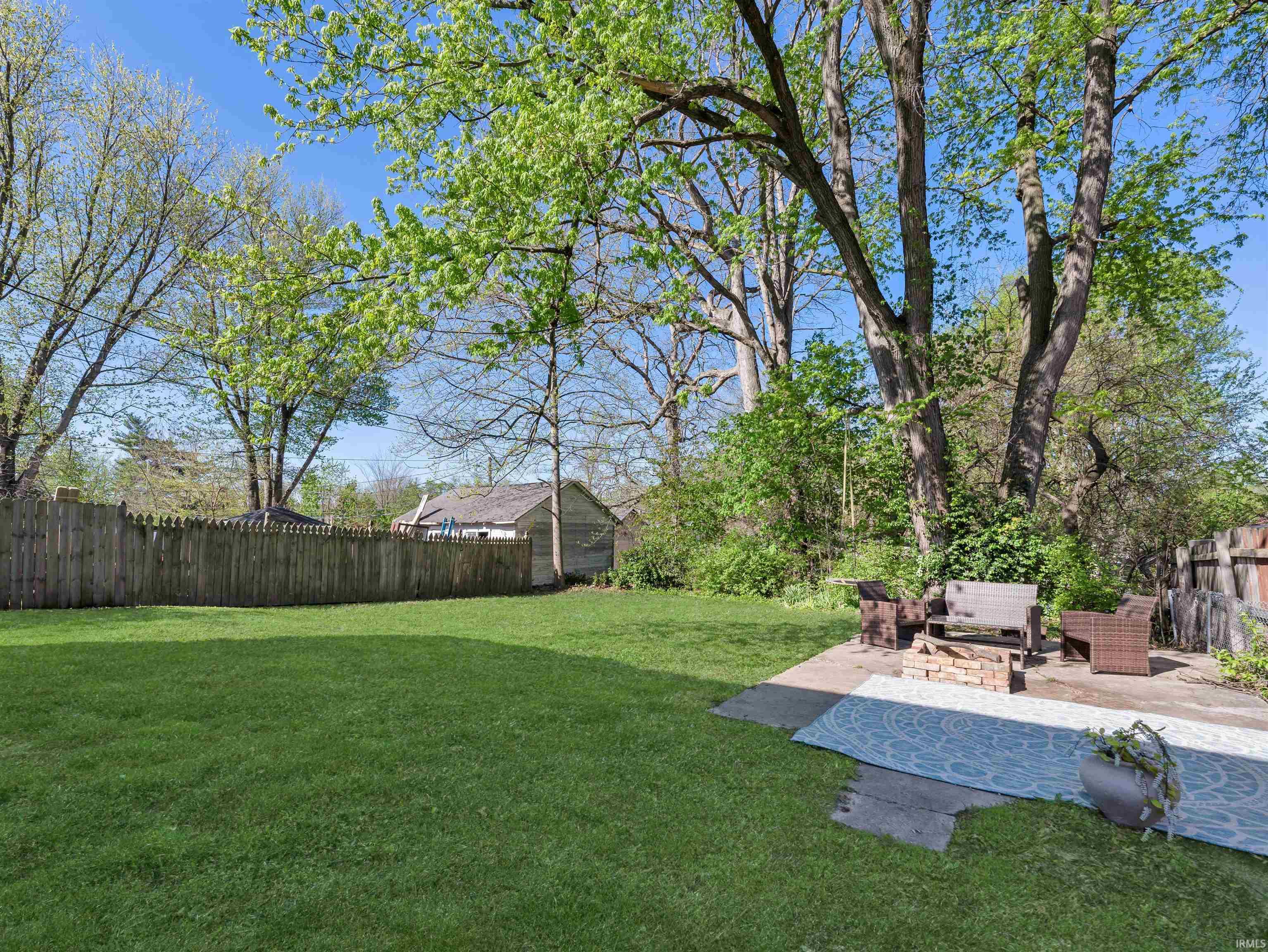 Fenced backyard with a patio area and outdoor furniture
