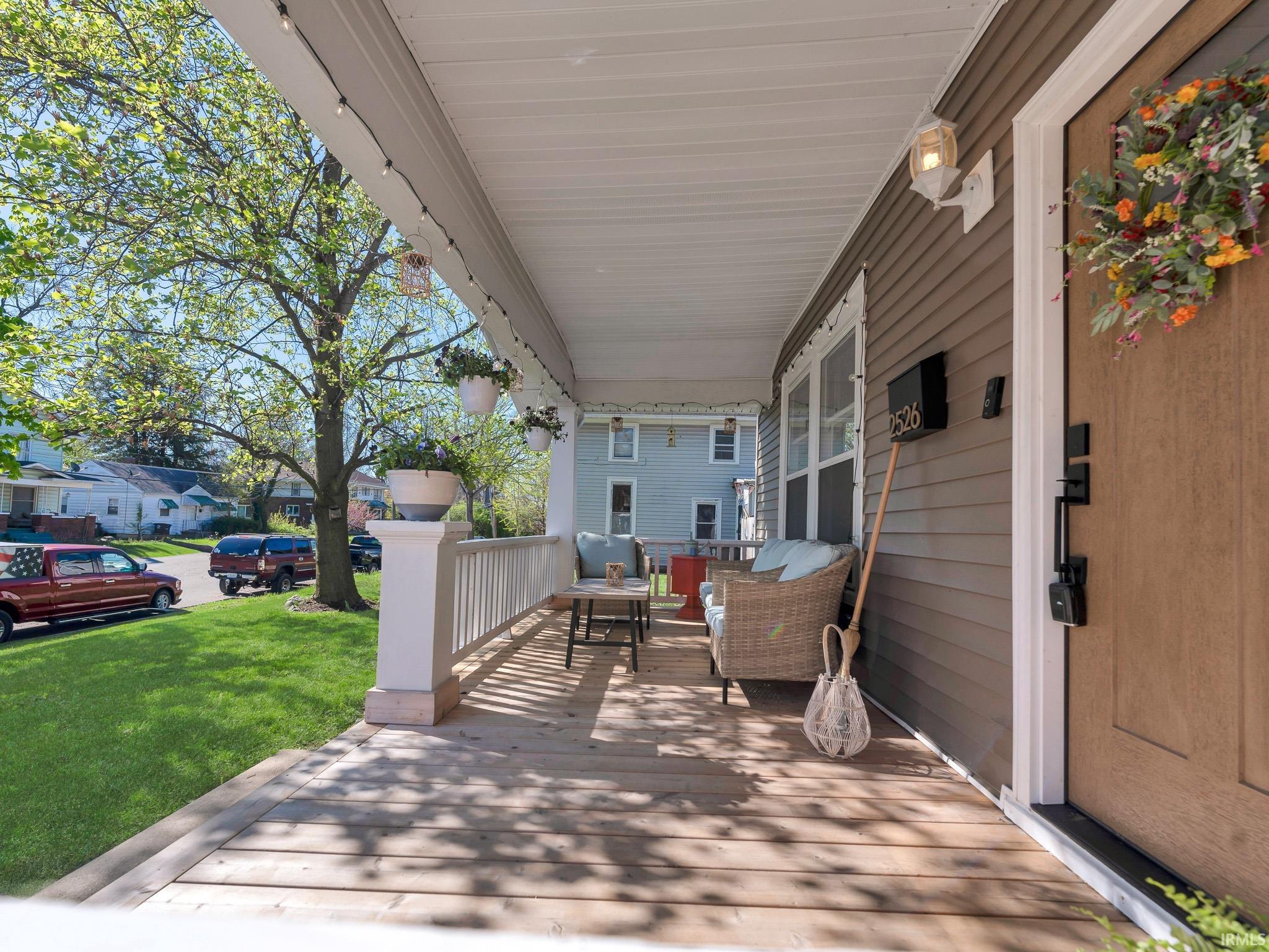 Porch featuring a lawn