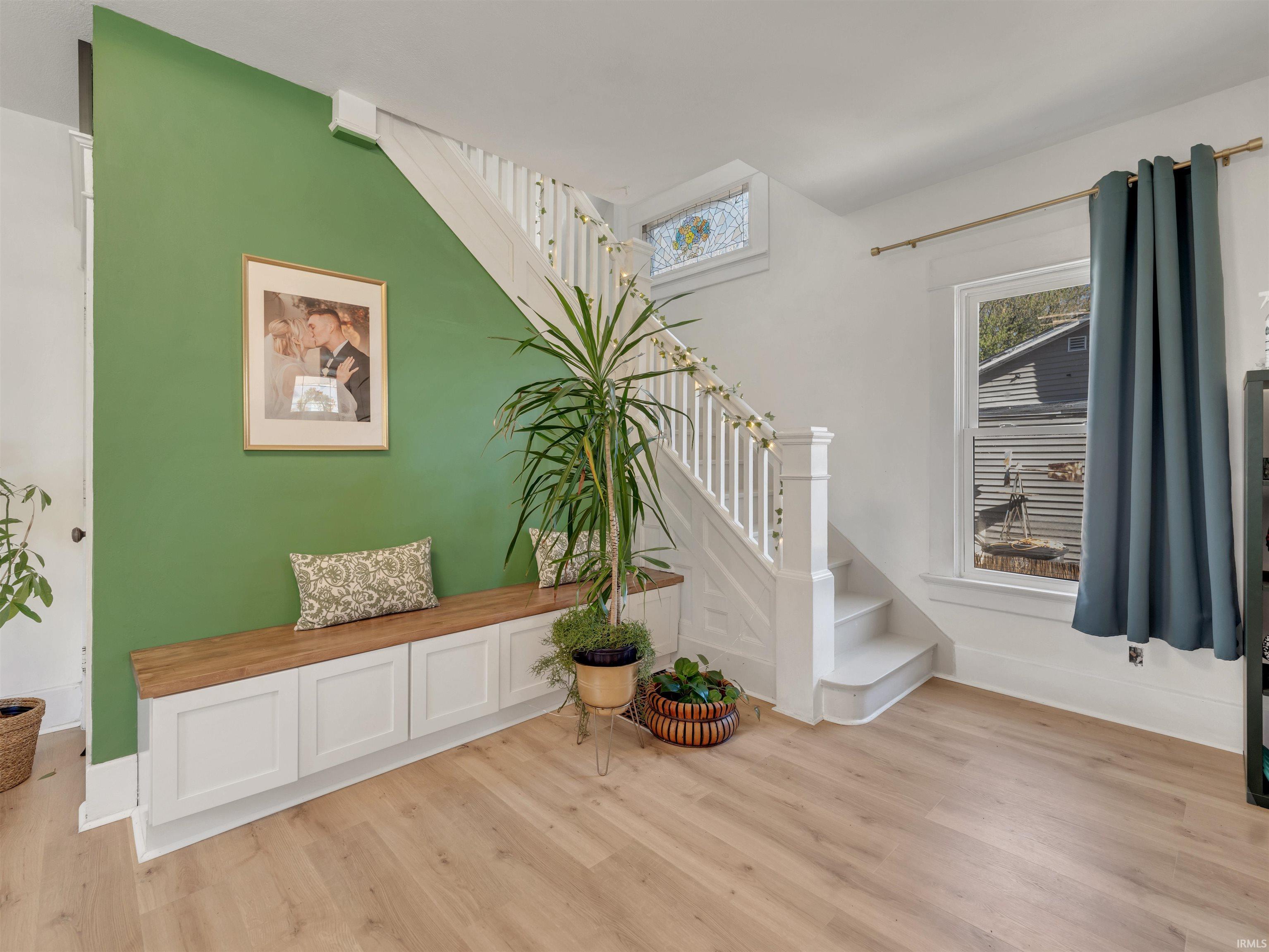 Entryway featuring stairs and light wood-style floors