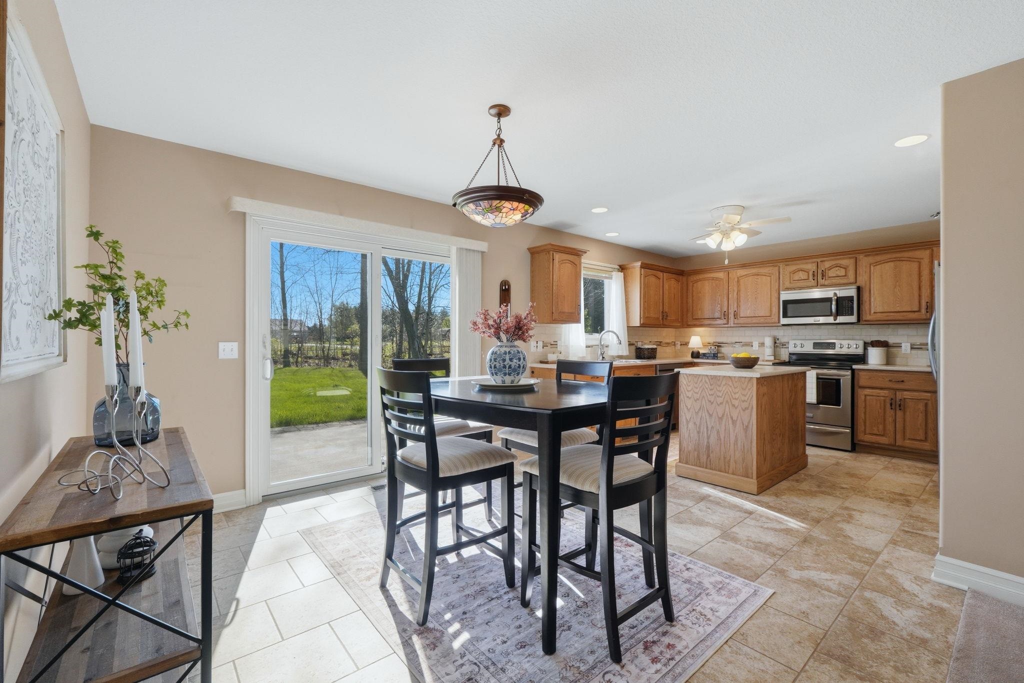 Dining area with recessed lighting, ceiling fan, and light tile patterned flooring