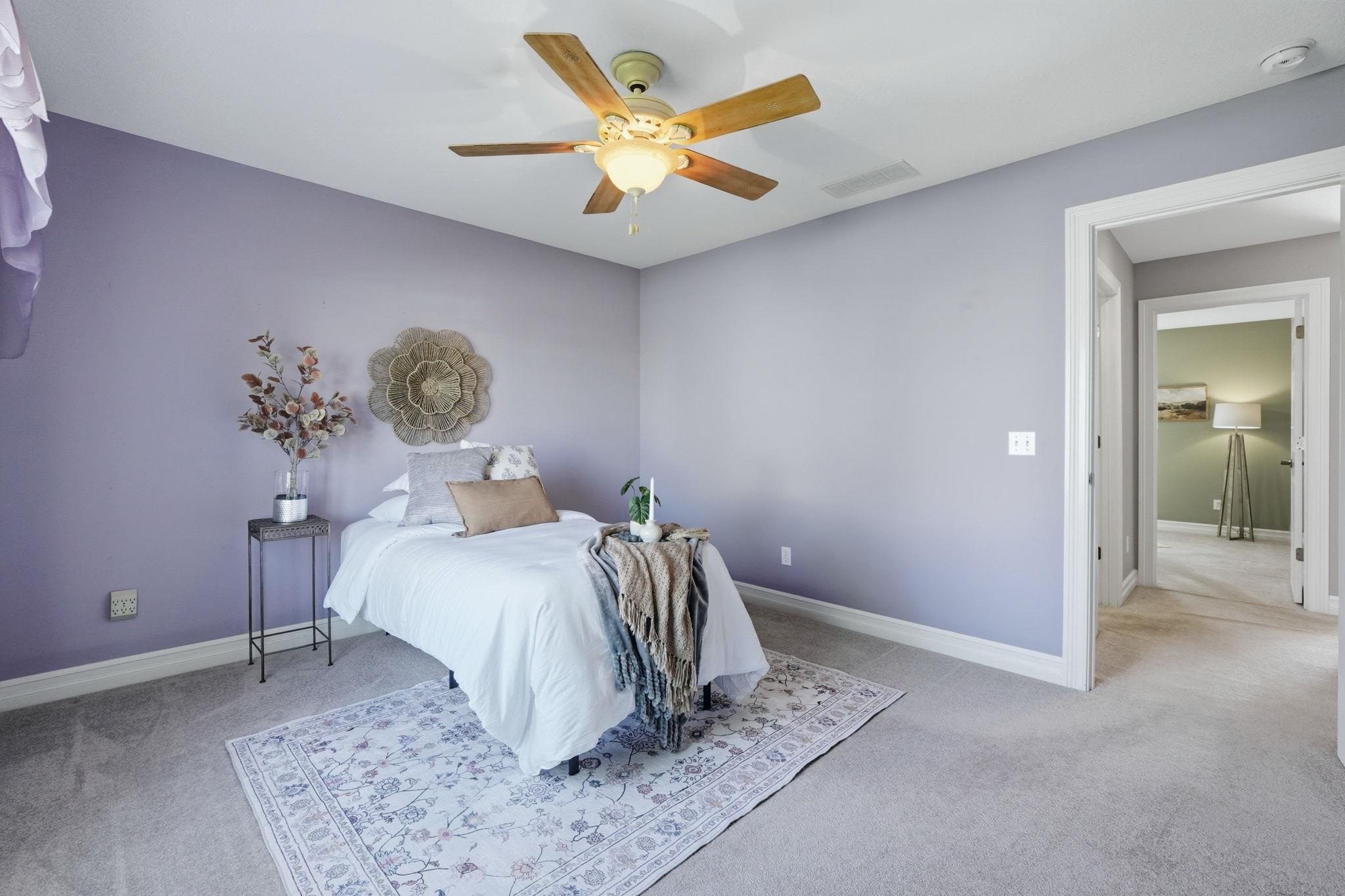 Bedroom featuring light colored carpet and a ceiling fan