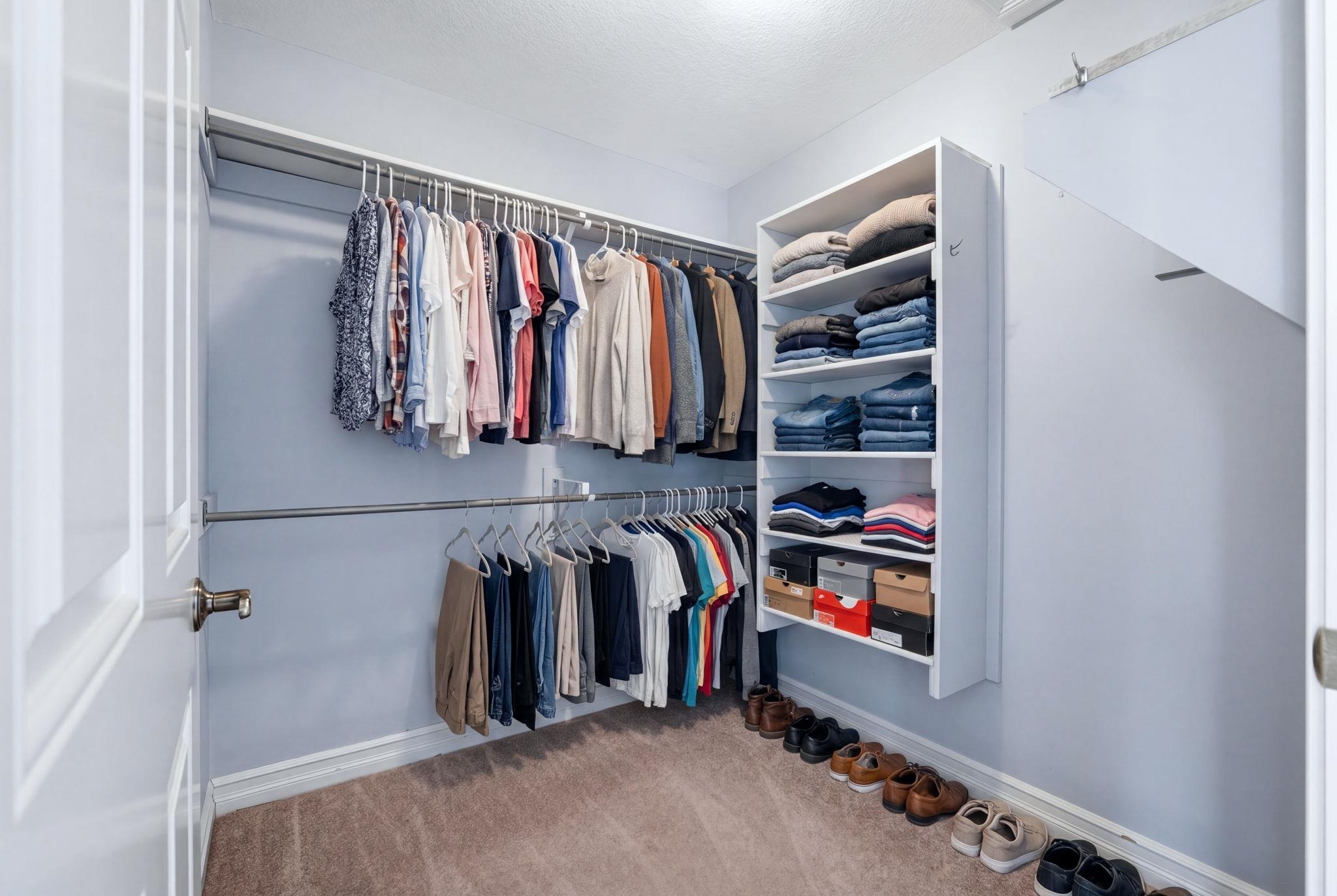 Walk in closet featuring light carpet