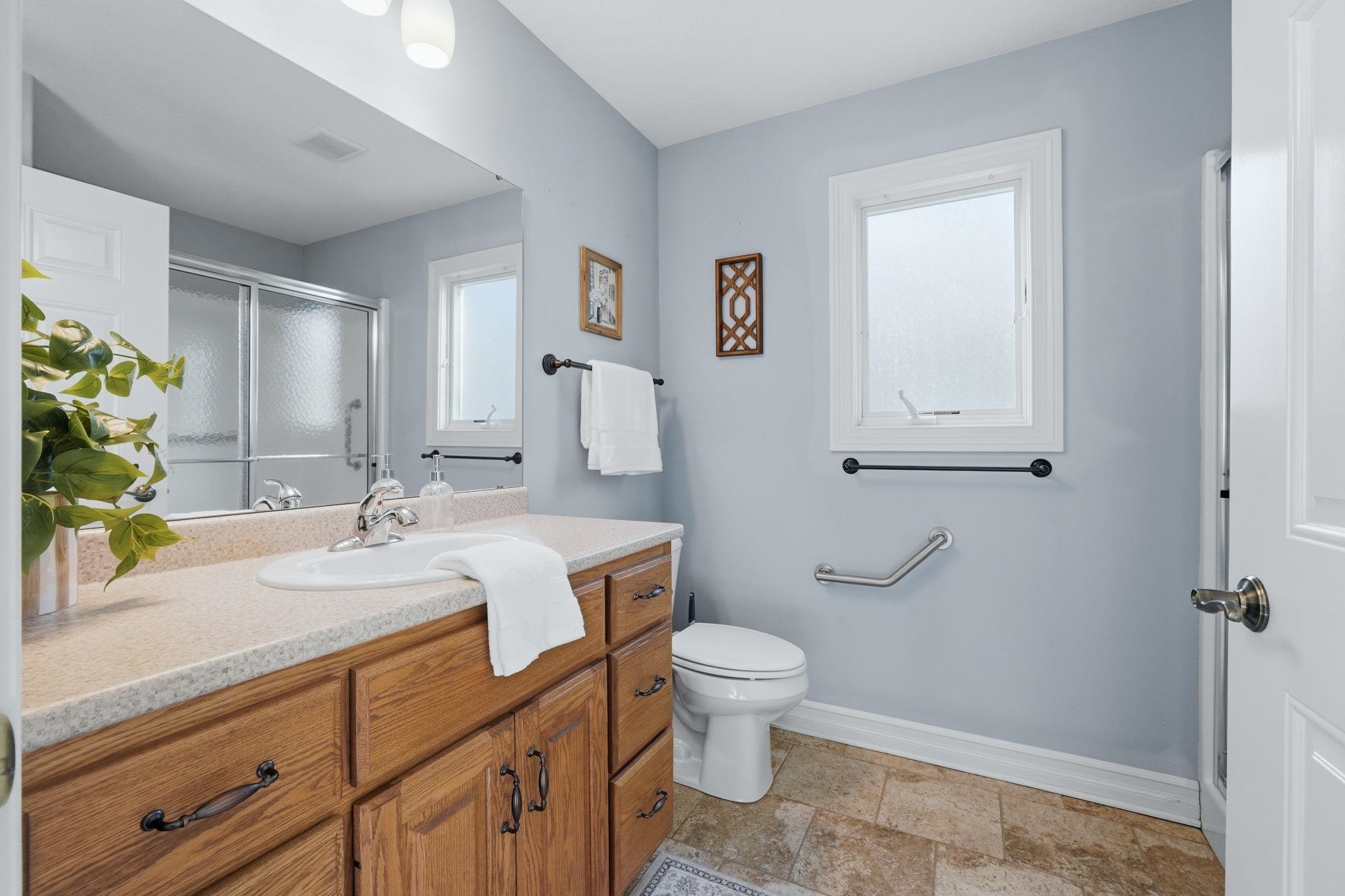 Full bathroom featuring vanity and a shower stall