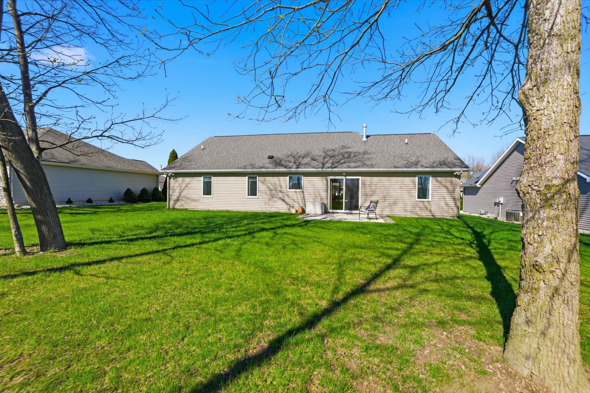 Back of property with a patio and a yard