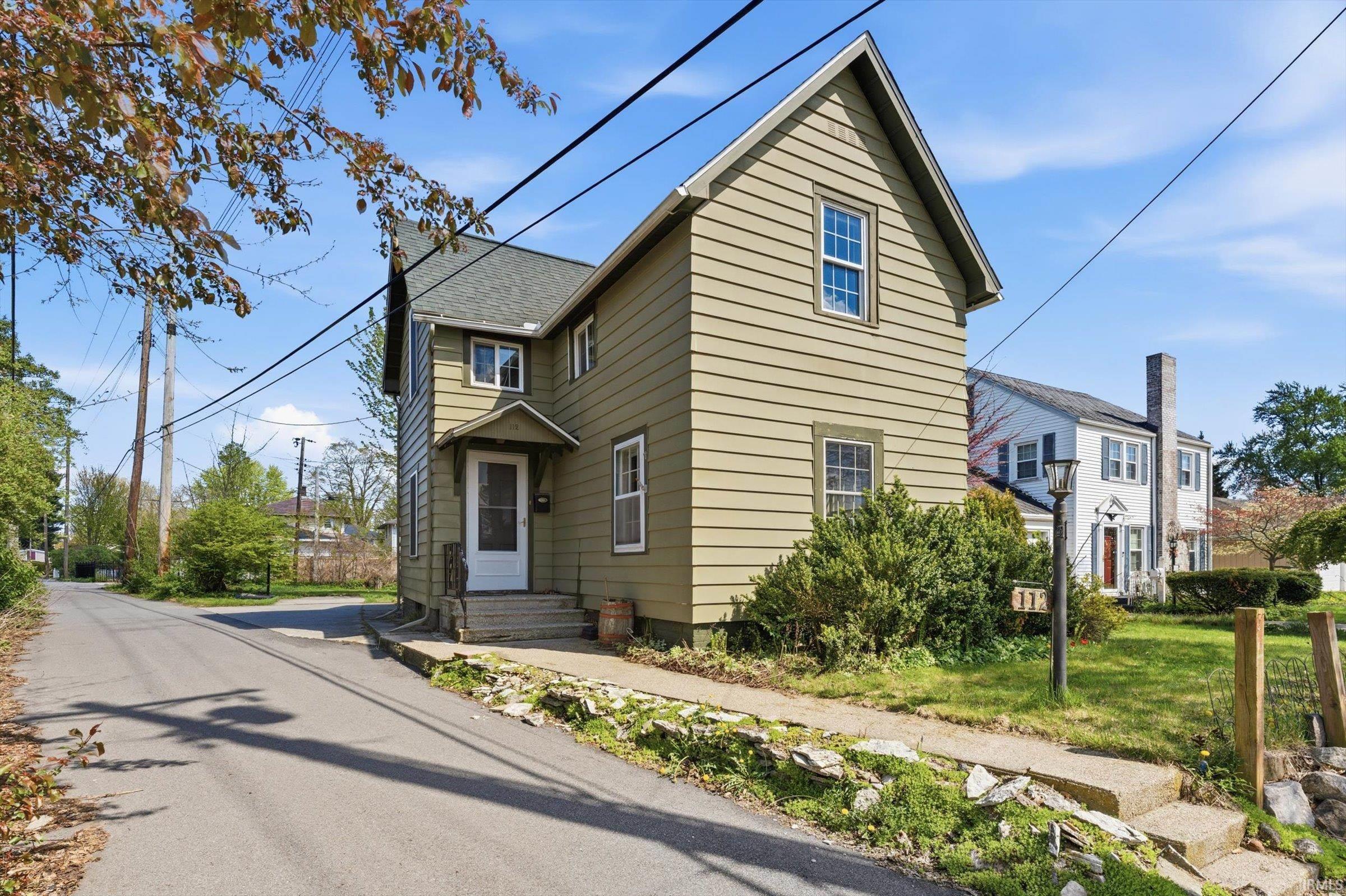Traditional home featuring a shingled roof