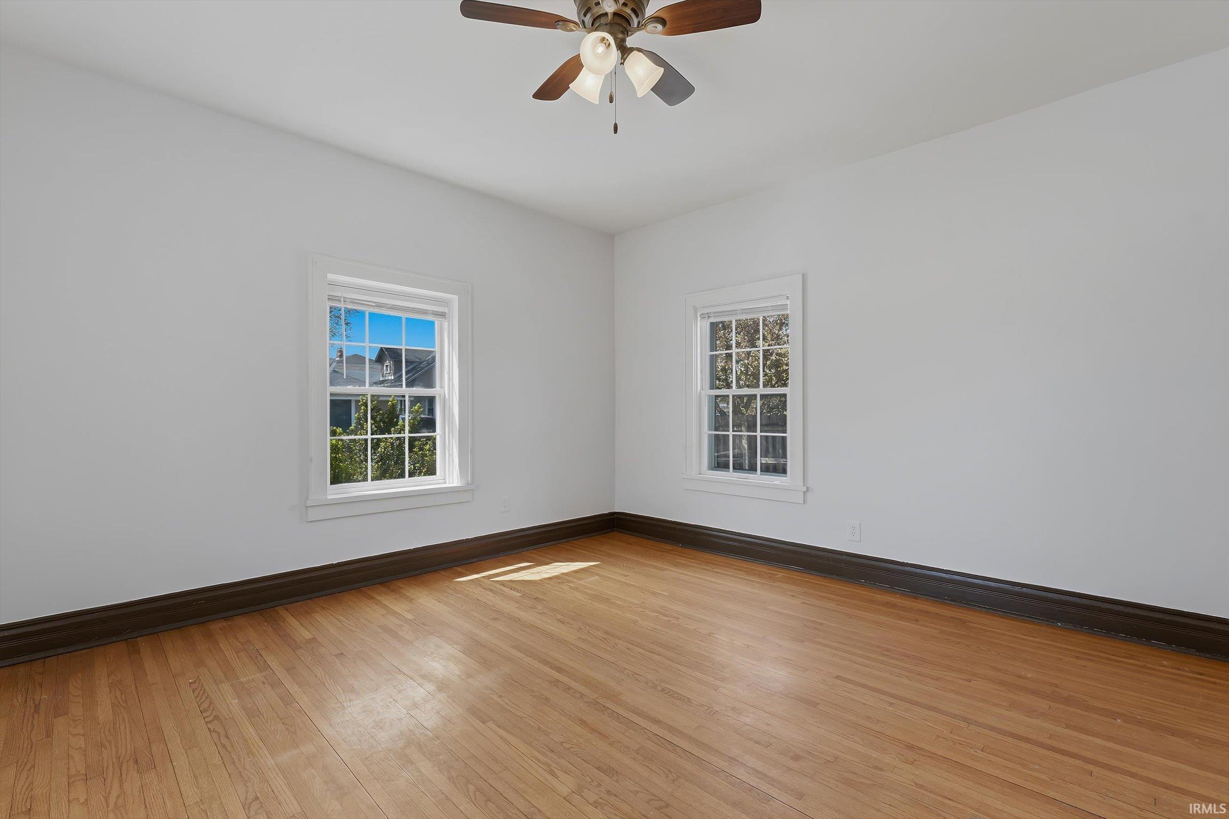 Spare room featuring light wood finished floors and ceiling fan